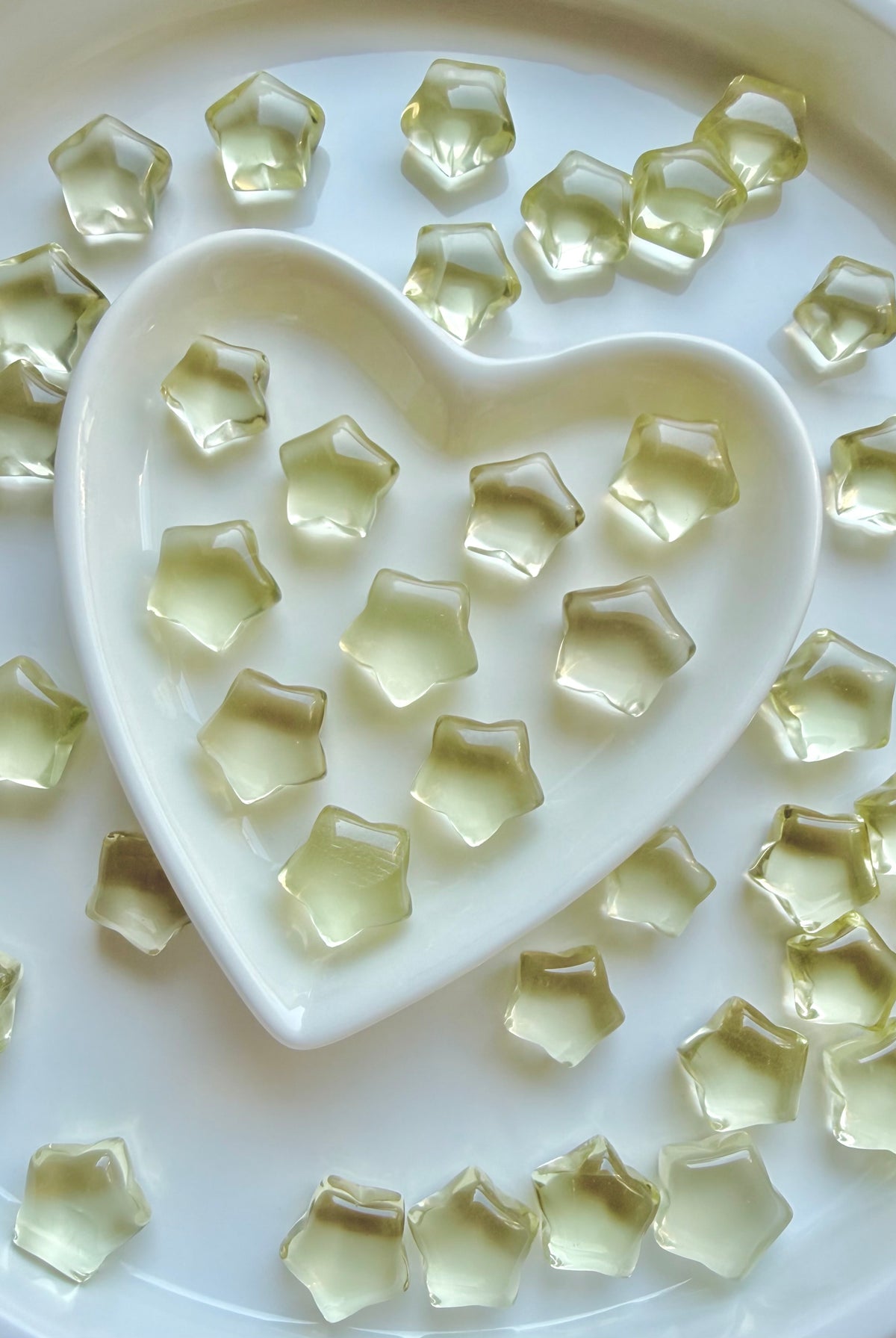 Mini Lemon Citrine stars arranged around a heart-shaped Selenite bowl filled with more golden Citrine stars