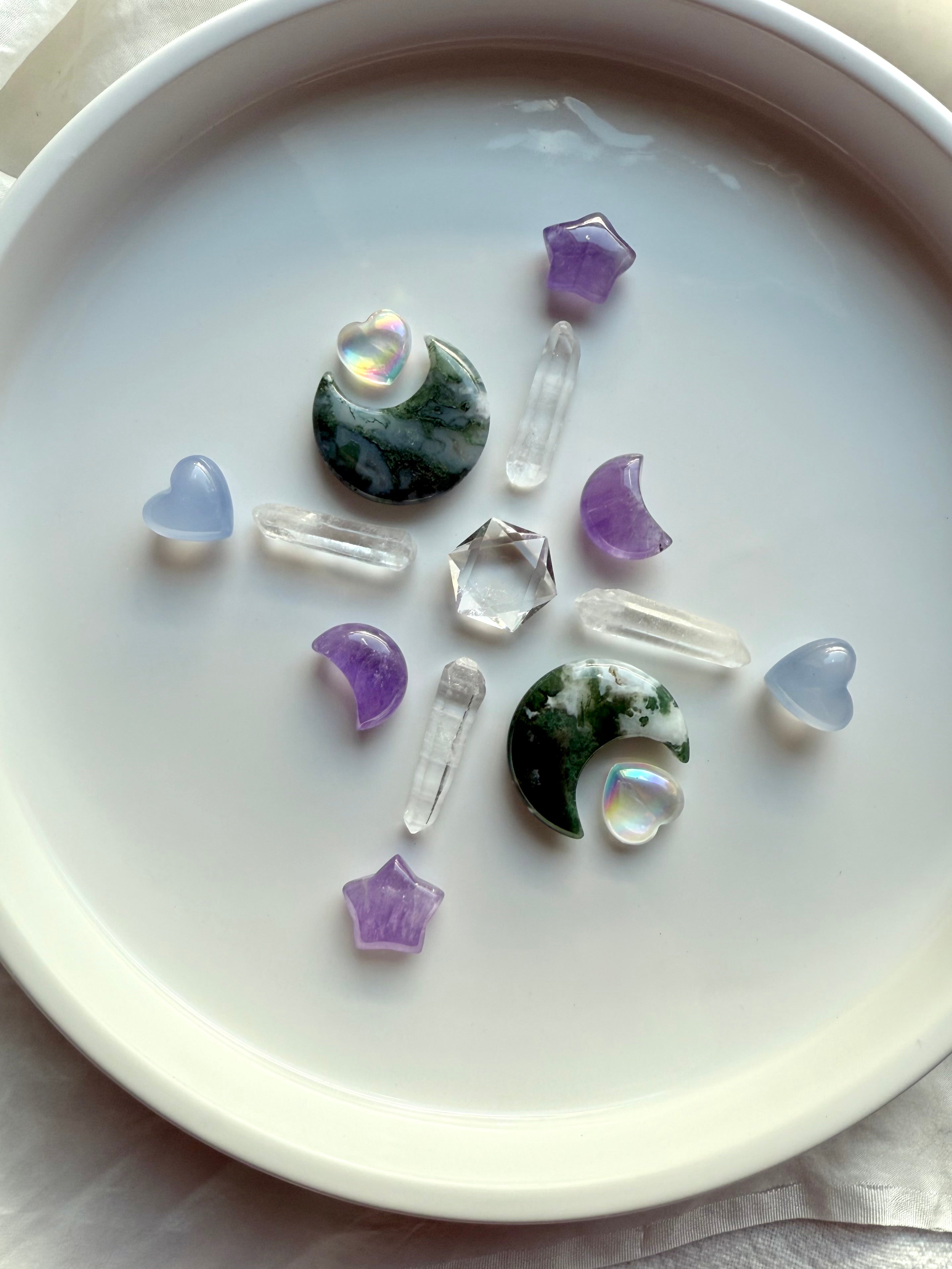 Mini Blue Chalcedony heart crystals arranged in a crystal grid with moss agate moons, amethyst, aura crystals, and clear quartz points, Throat Chakra stones for calm communication, harmony, and intentional energy work
