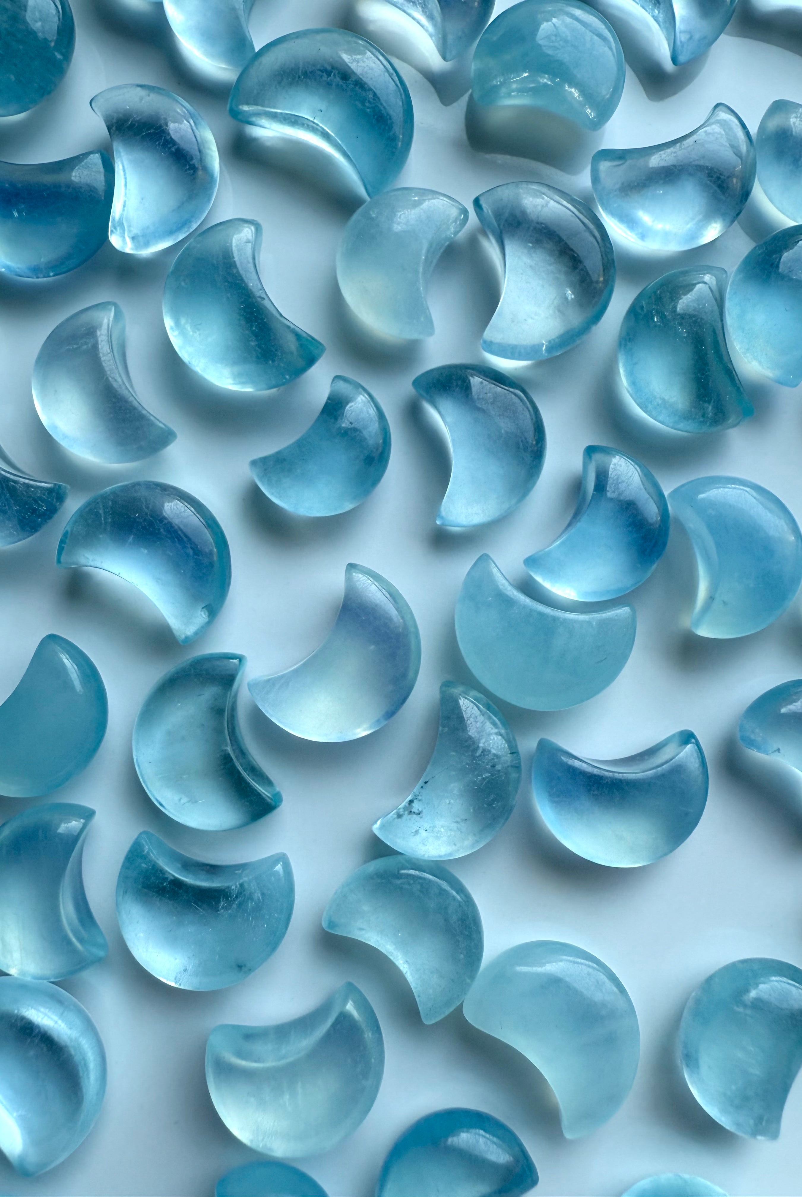 Closeup of polished Aquamarine Mini Moons showing high-clarity gemstone detail and color variation — ideal for mini altars and pocket talismans