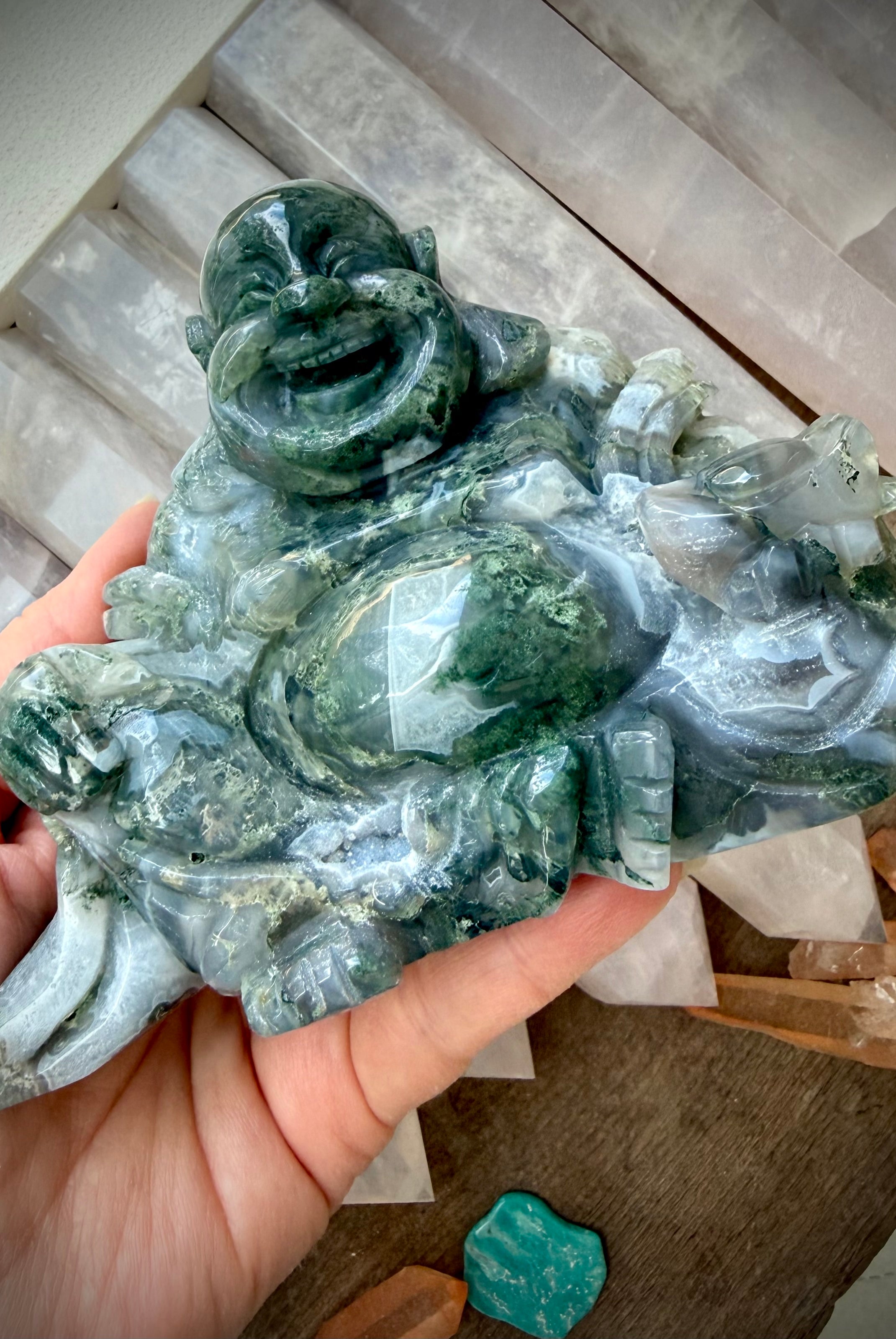 Angled view of a Large Moss Agate Laughing Buddha statue with scenic Moss Agate patterns