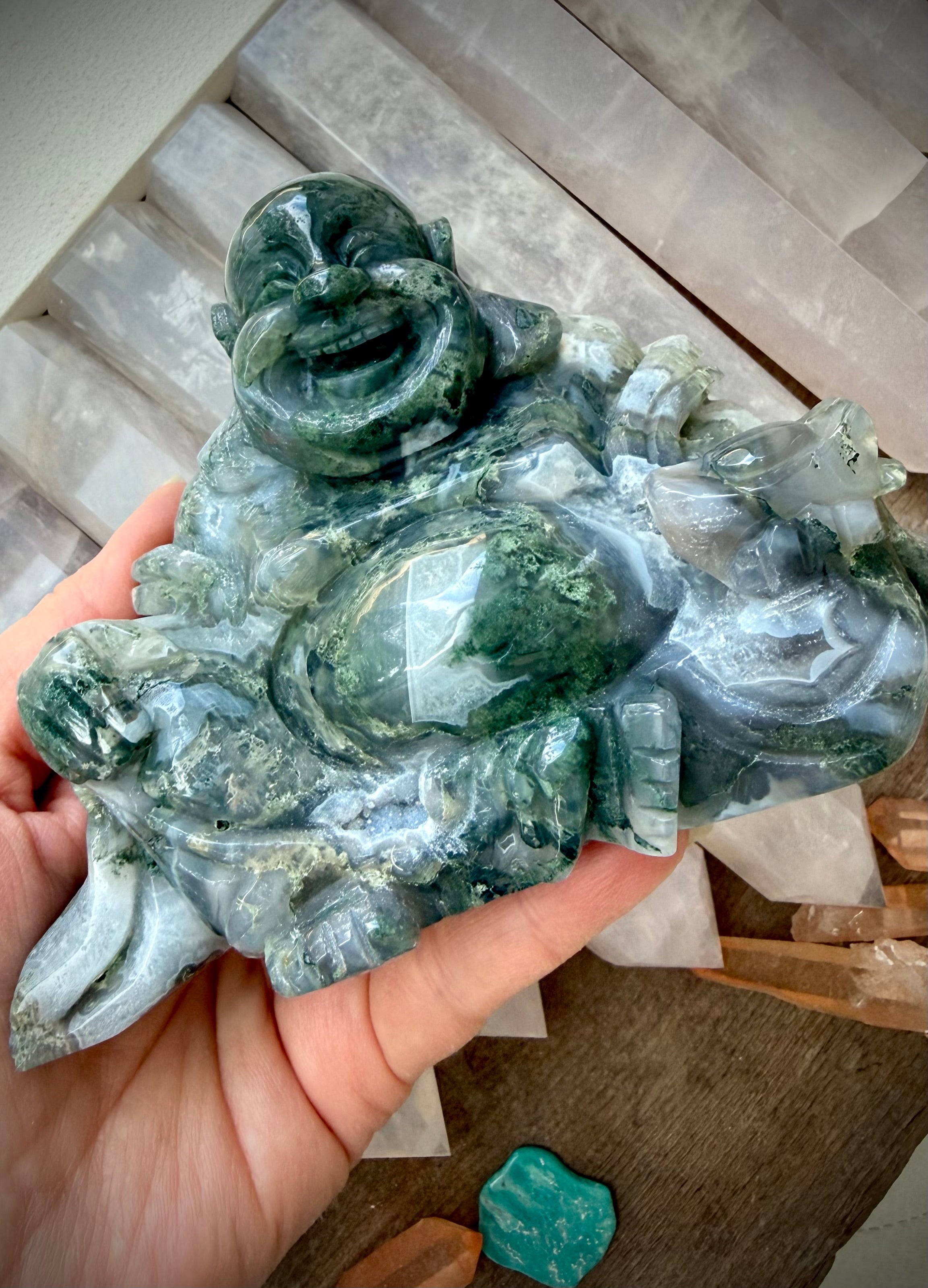 Angled view of a Large Moss Agate Laughing Buddha statue with scenic Moss Agate patterns