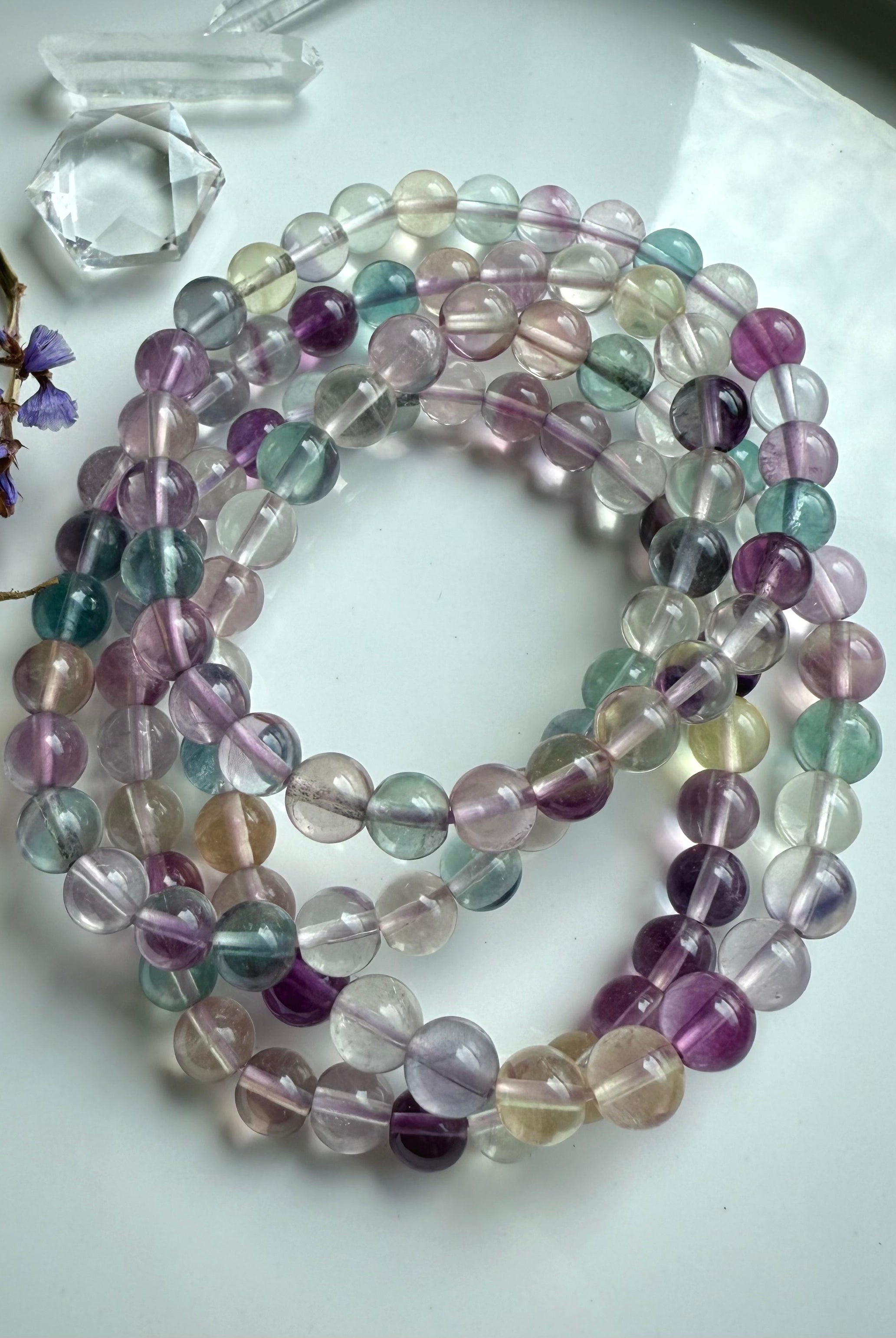 Group of mixed color fluorite crystal bracelets highlighting clarity, polish, and natural gemstone translucence