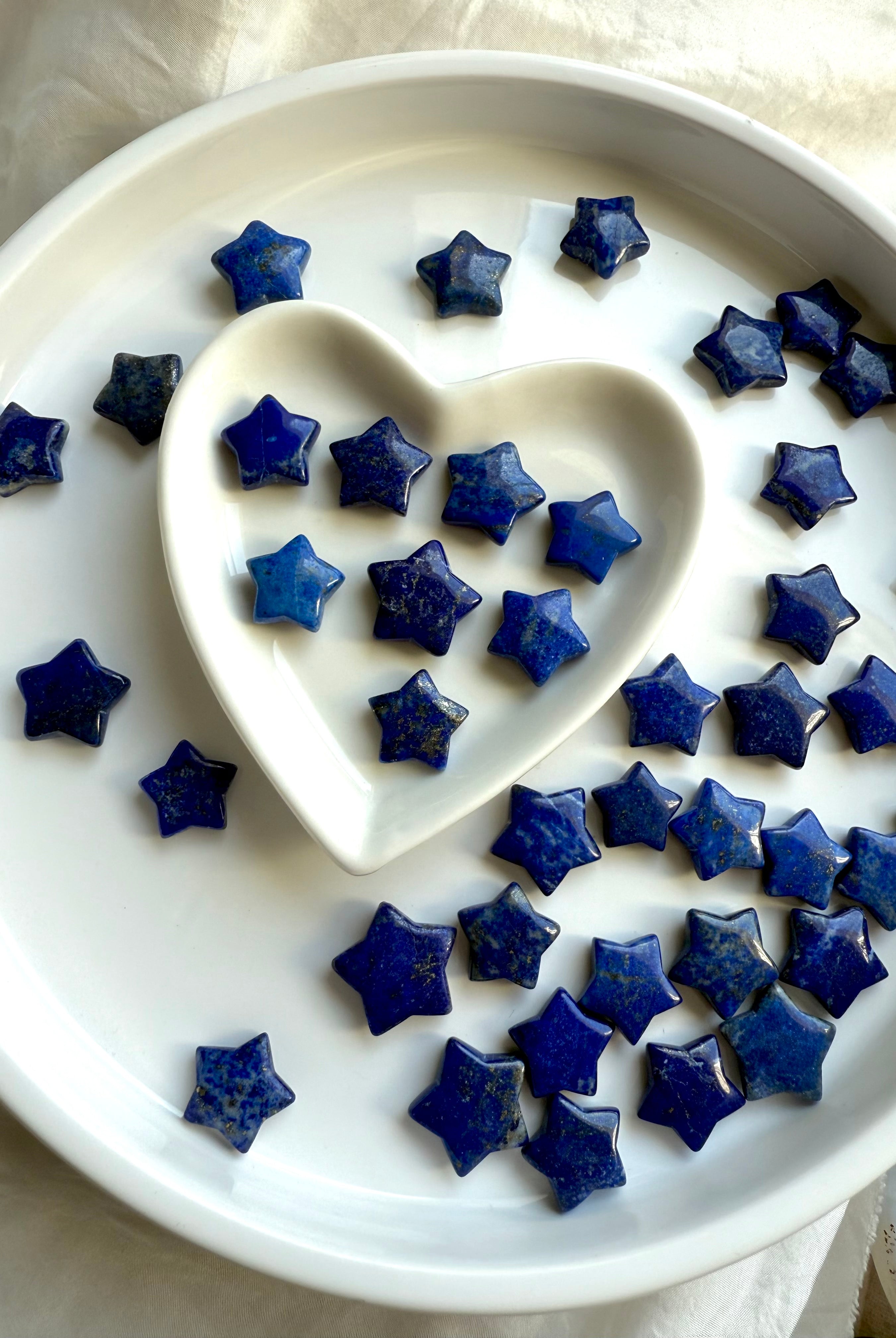 Mini blue Lapis Lazuli star carvings with glossy finish and celestial patterns