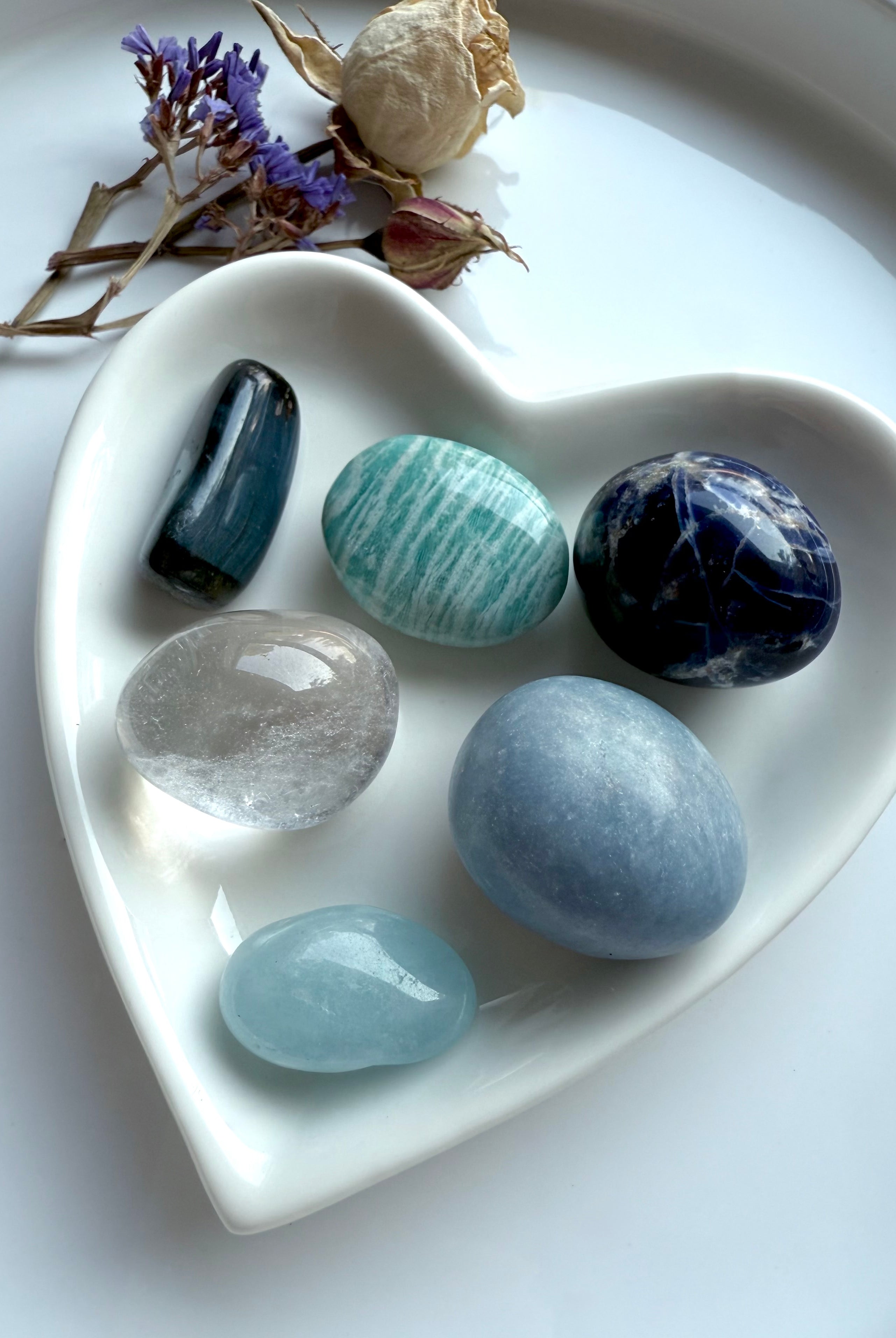 Throat Chakra Crystal Set in white heart-shaped dish with dried flowers — six healing stones for communication and creativity