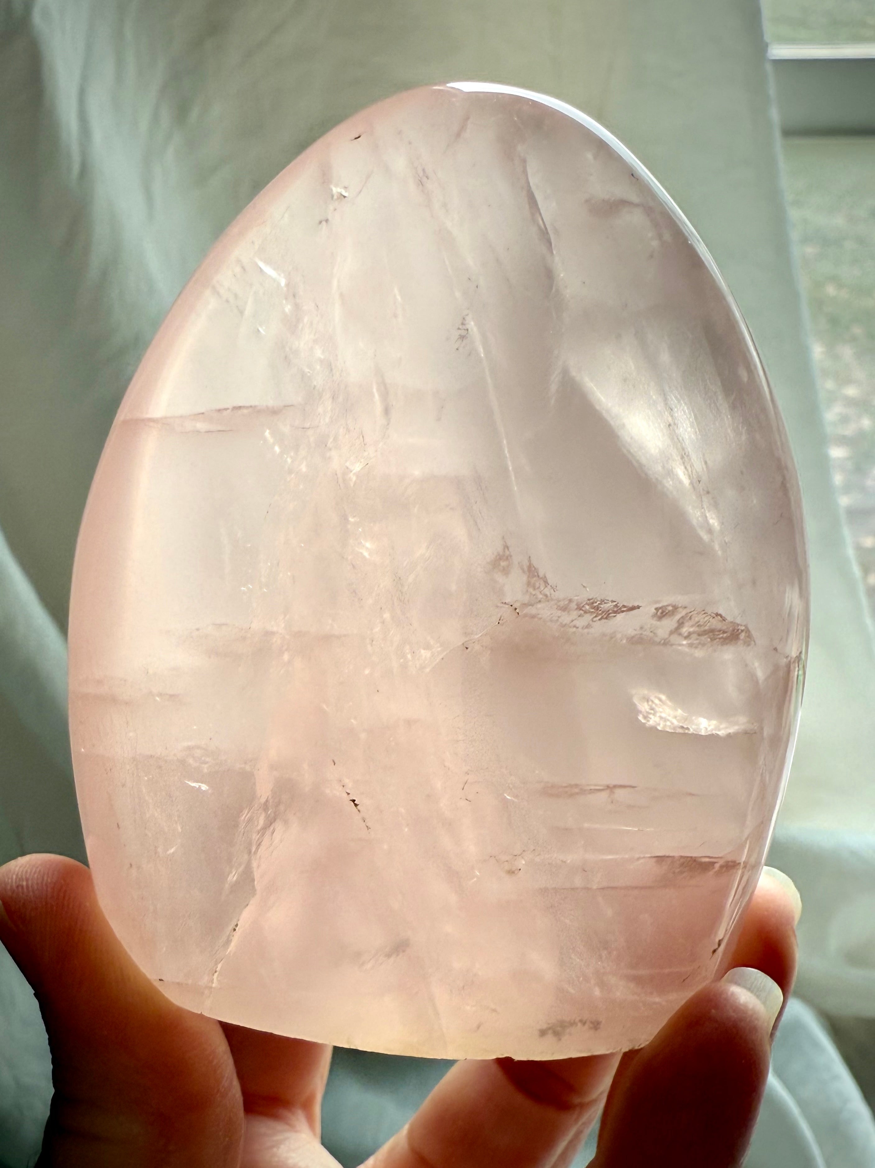 Premium Rose Quartz freeform stone with glassy pink translucence and mystical light-filled appearance