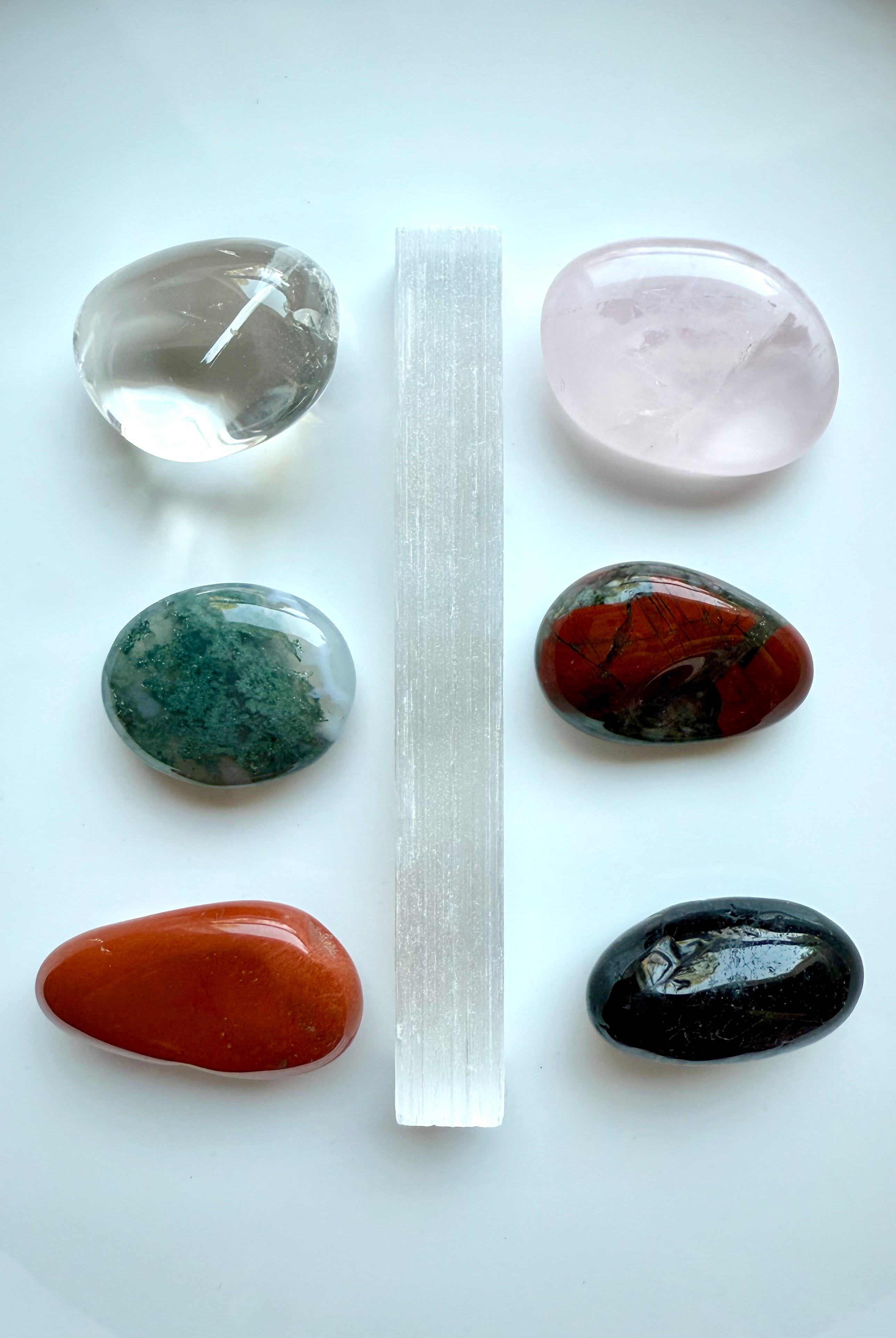 Get Well healing crystals arranged in a grid layout, featuring Rose Quartz, Selenite, Bloodstone, & more