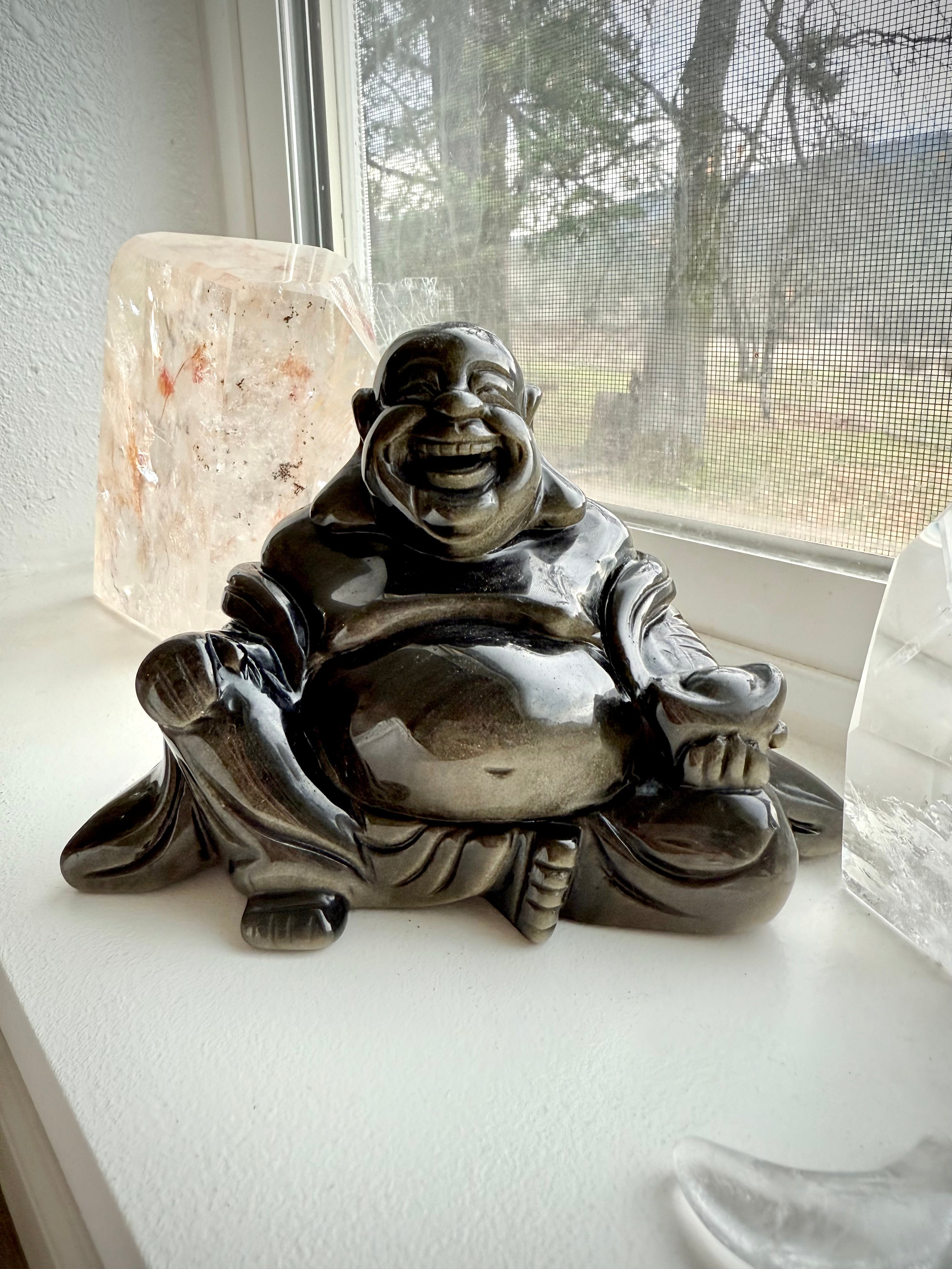 Golden Sheen Obsidian Buddha statue on windowsill with quartz and crystal moon – grounding altar decor for healing and spiritual balance
