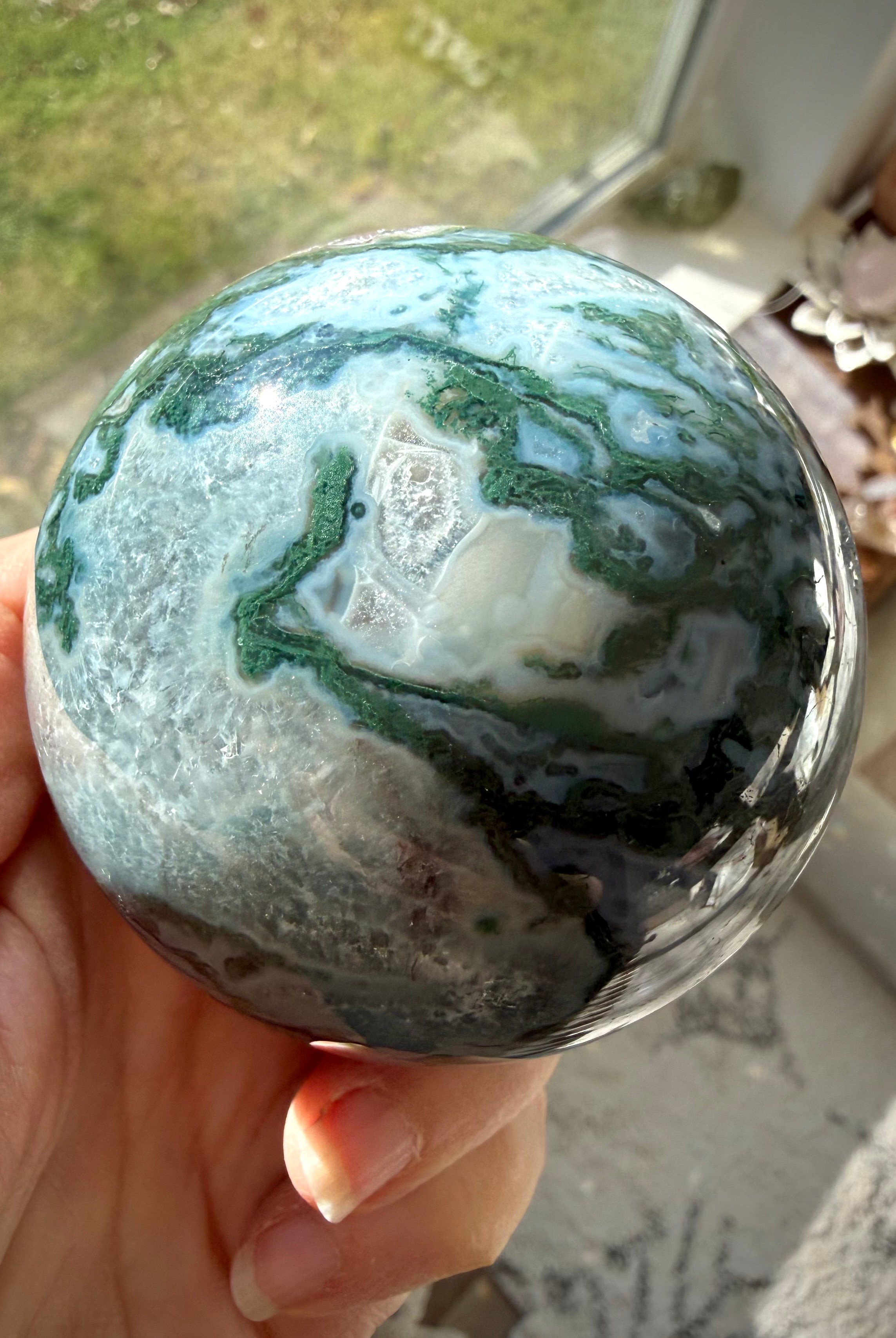 Moss Agate sphere with natural Quartz inclusions, green mineral patterns, and unique crystal formations