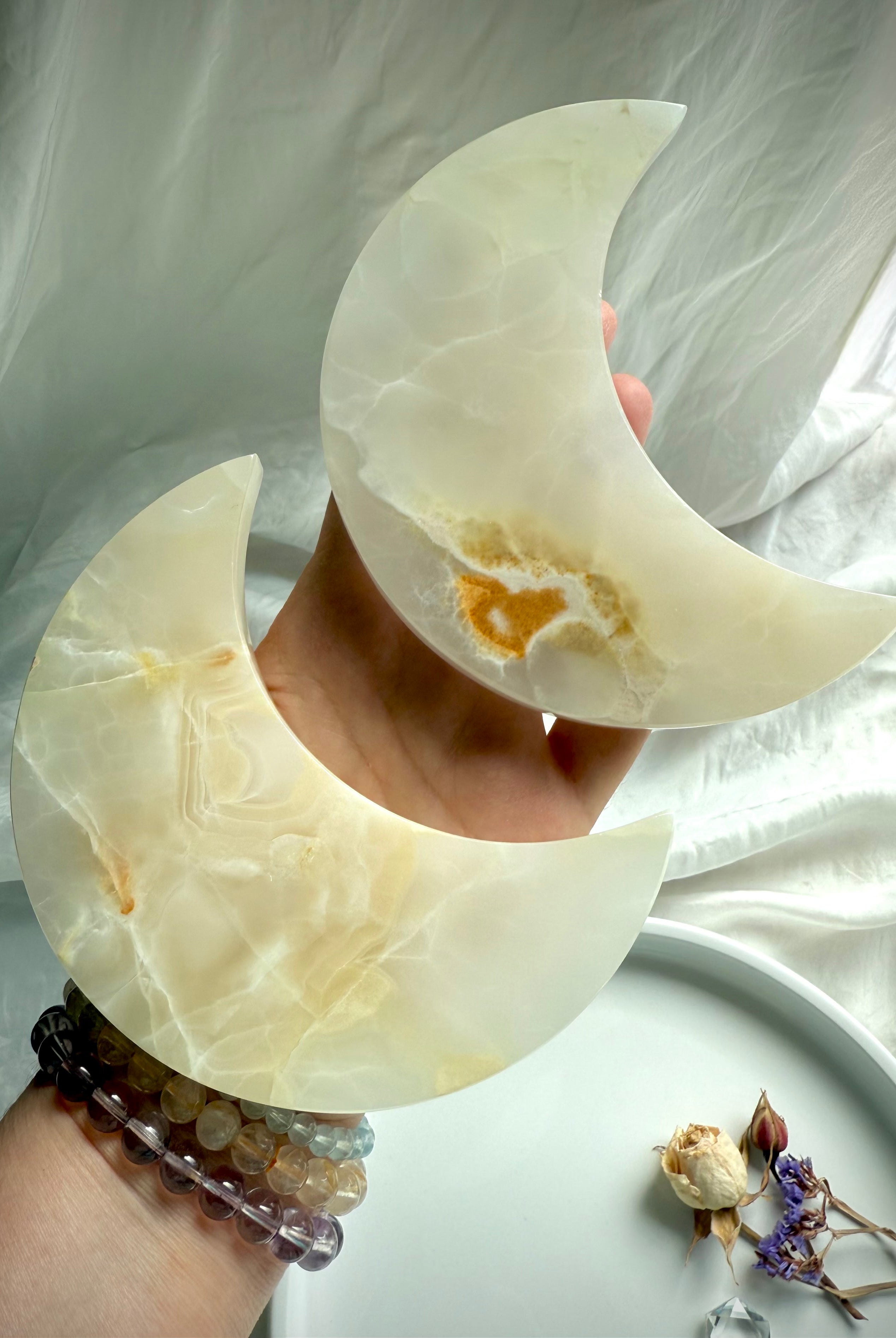 White Onyx Crescent Moon Plates – crystal carvings with creamy white and honey tones for altar decor and lunar rituals