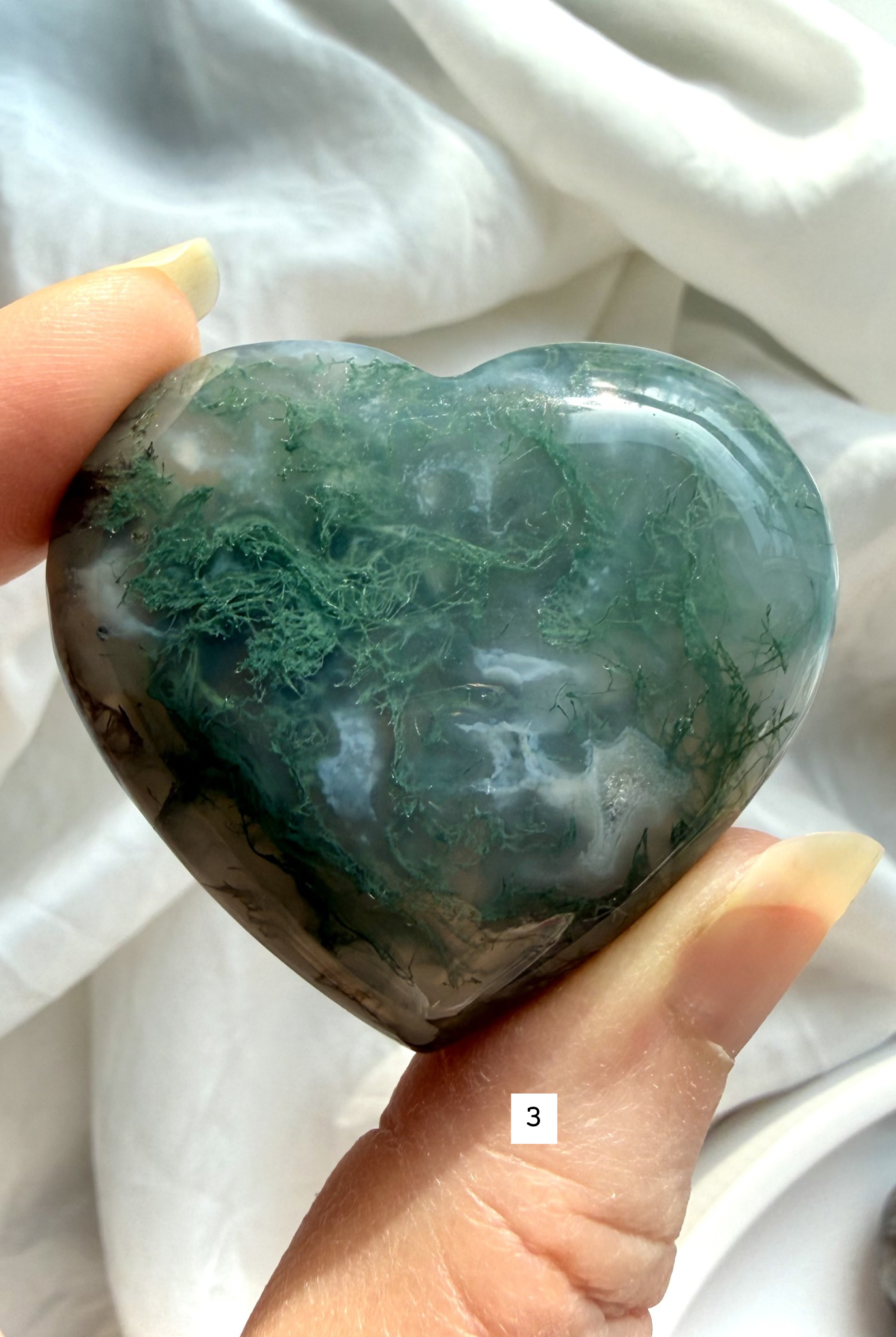 moss agate heart carving option 3 in hand with detailed moss pattern and soft white chalcedony banding