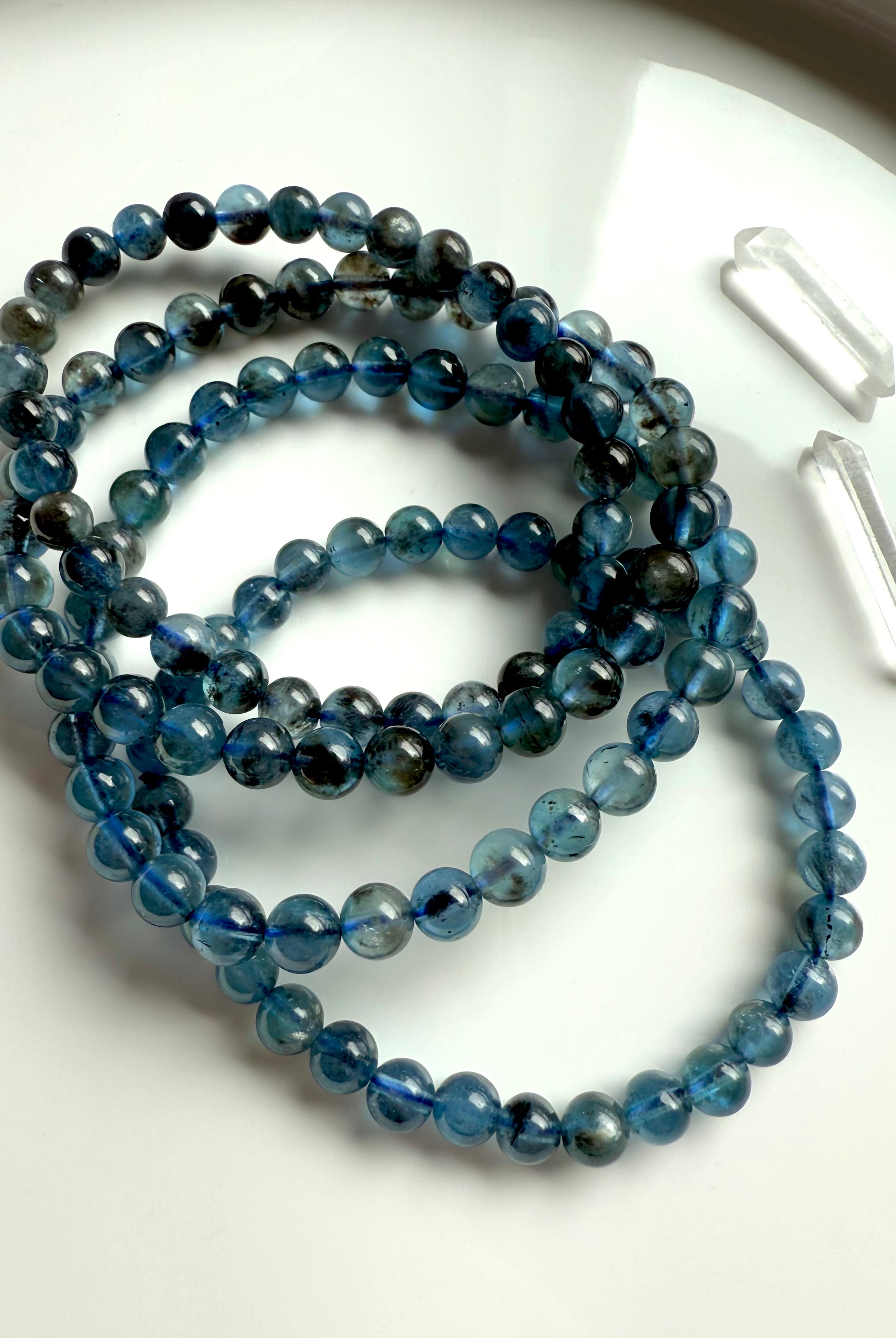 Deep blue Aquamarine Bracelets aka Devil Aquamarine photographed in natural light on a white plate