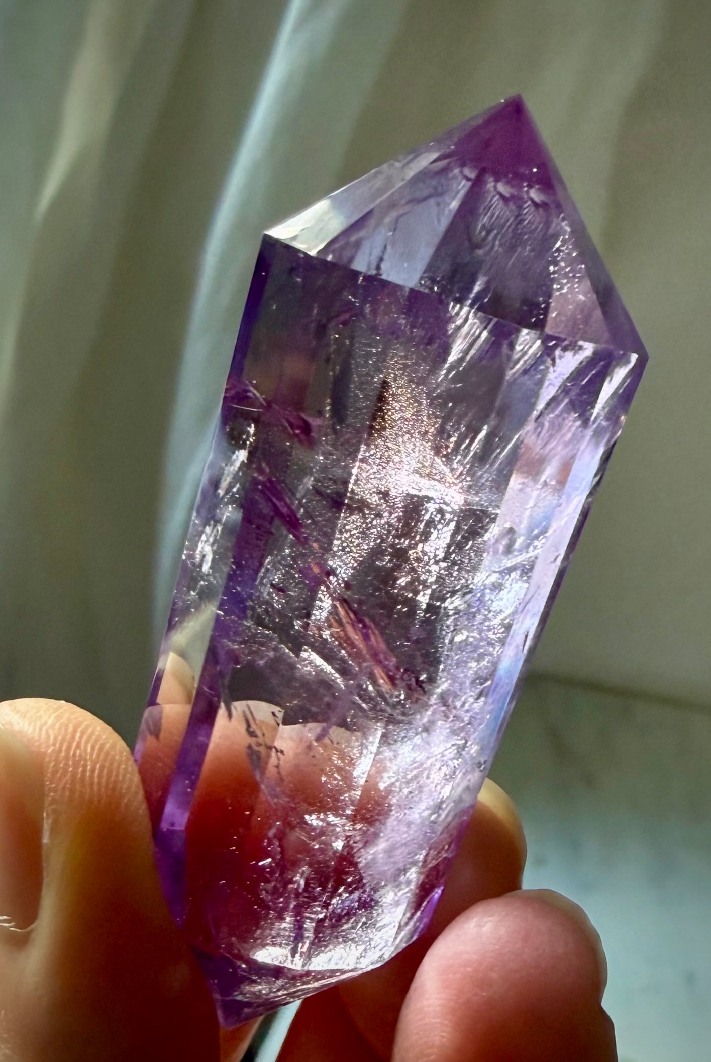 Amethyst Vogel cut crystal wand with high clarity, rich violet color, and rainbow flashes