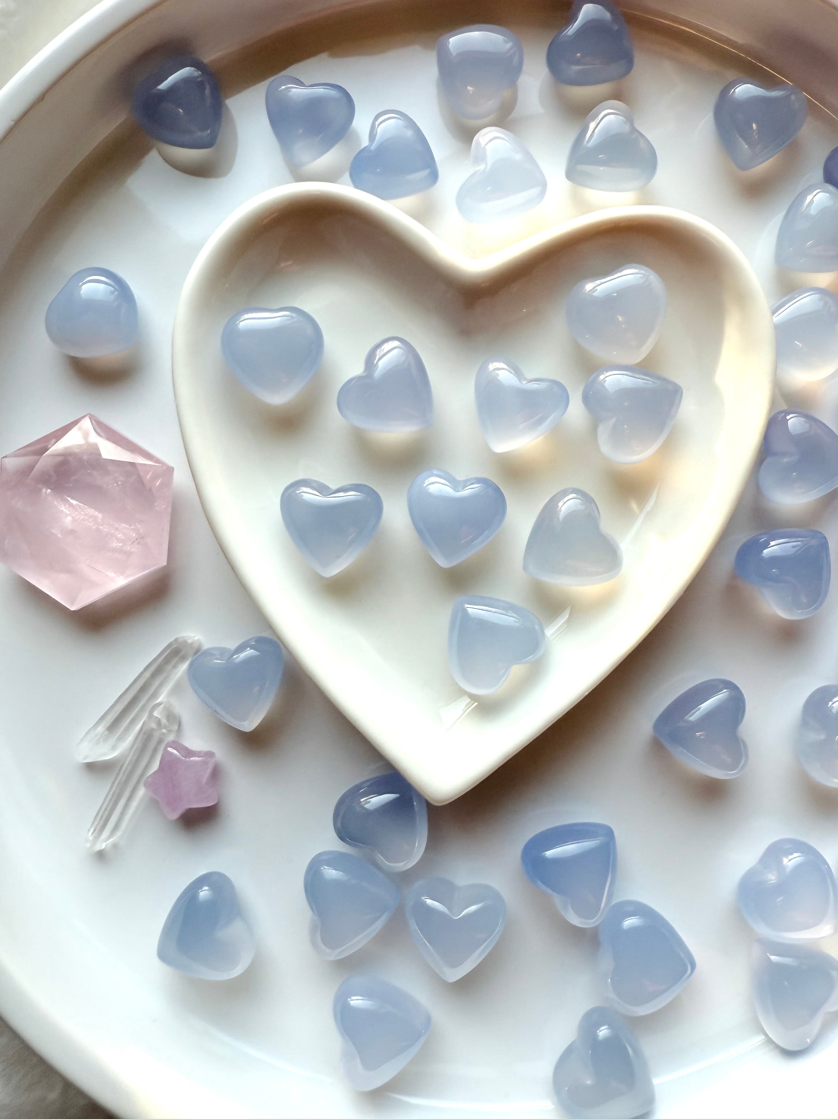 Blue Chalcedony heart stones arranged in a heart dish for crystal rituals, calming gemstones for communication and emotional balance
