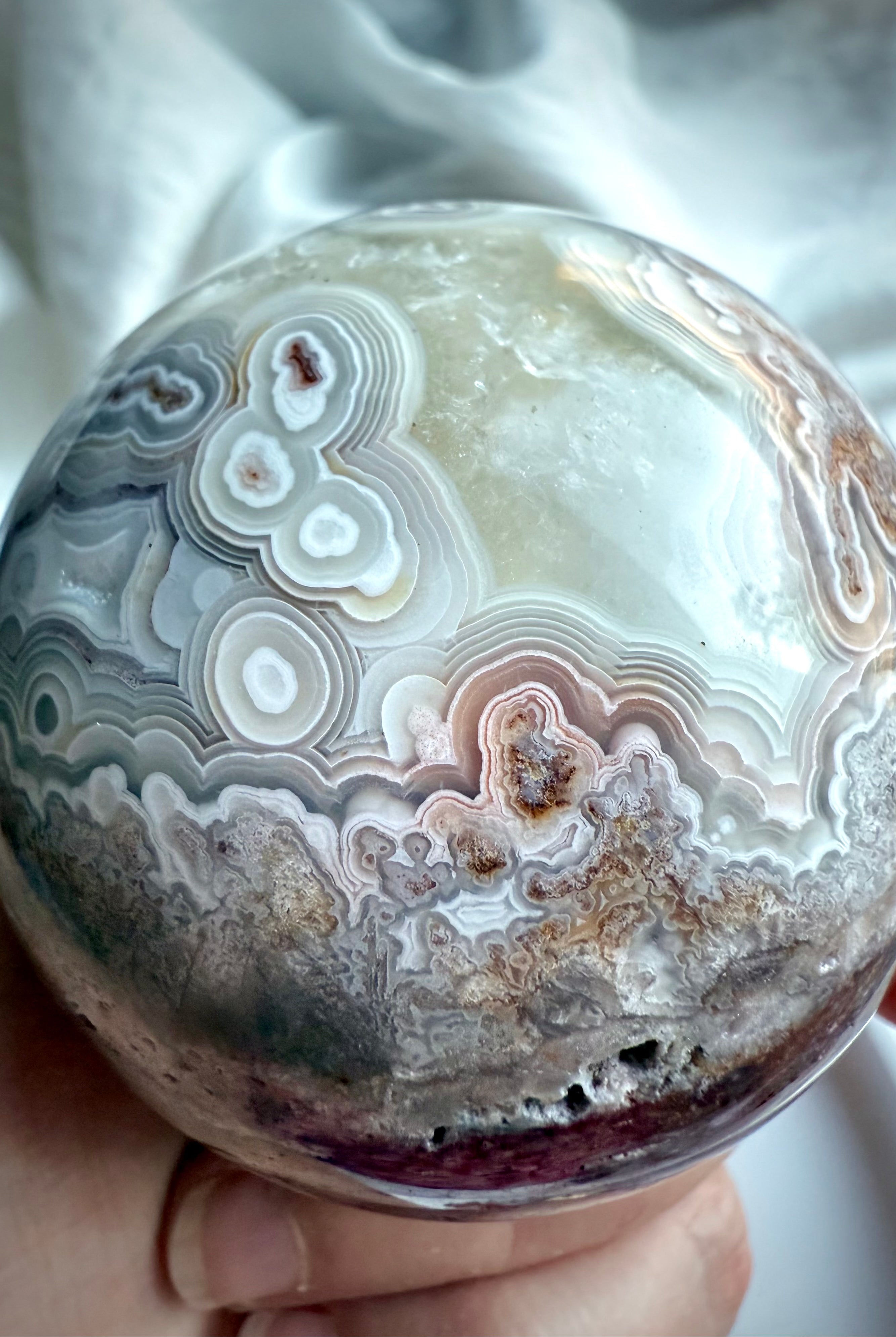 Crazy Lace Agate sphere with lavender and mauve tones, intricate lace-like banding, and natural druzy textures
