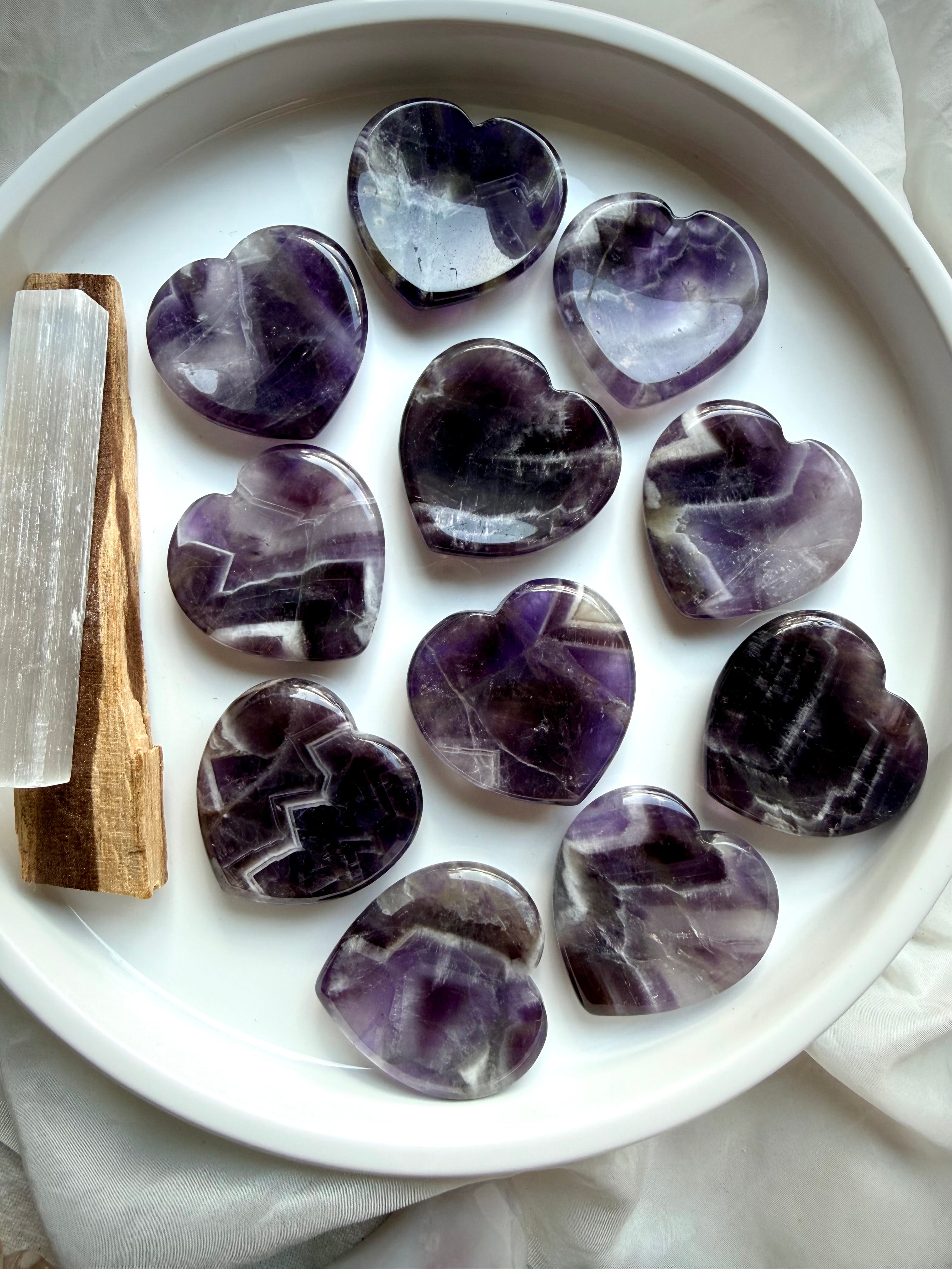 dream amethyst heart worry stones on dish with selenite for calm intuition and clarity