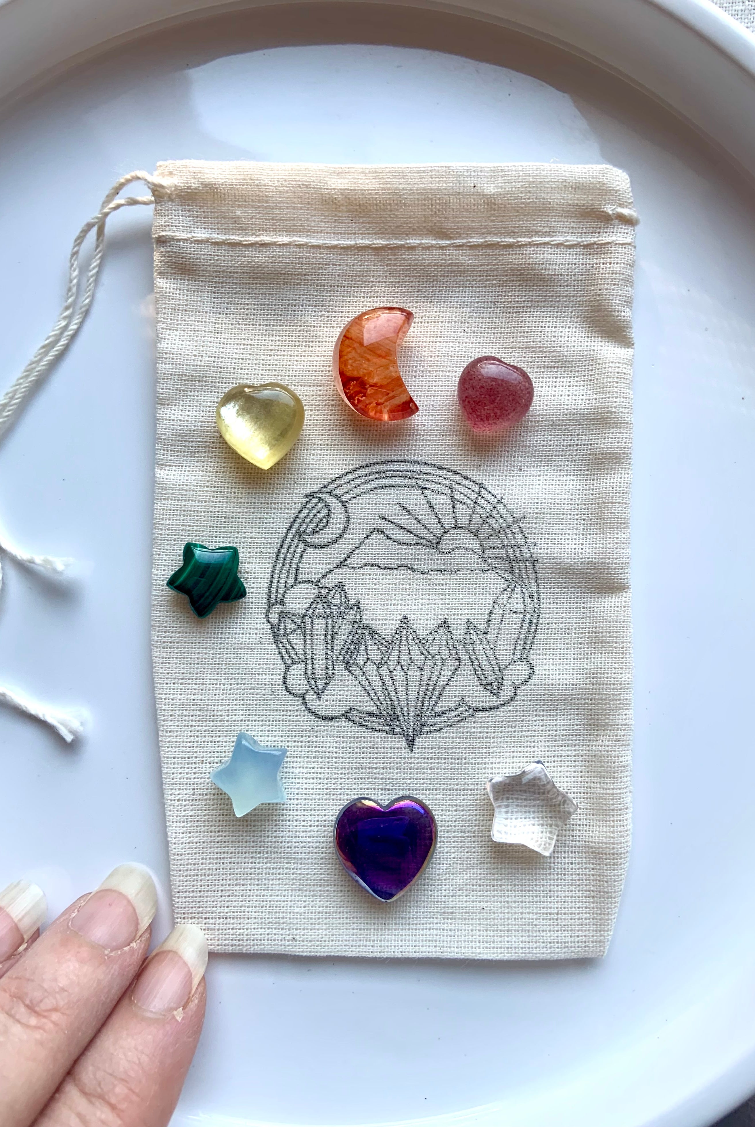 Chakra crystal set with 7 mini carved gems — heart, moon & star shapes in rainbow colors with pouch