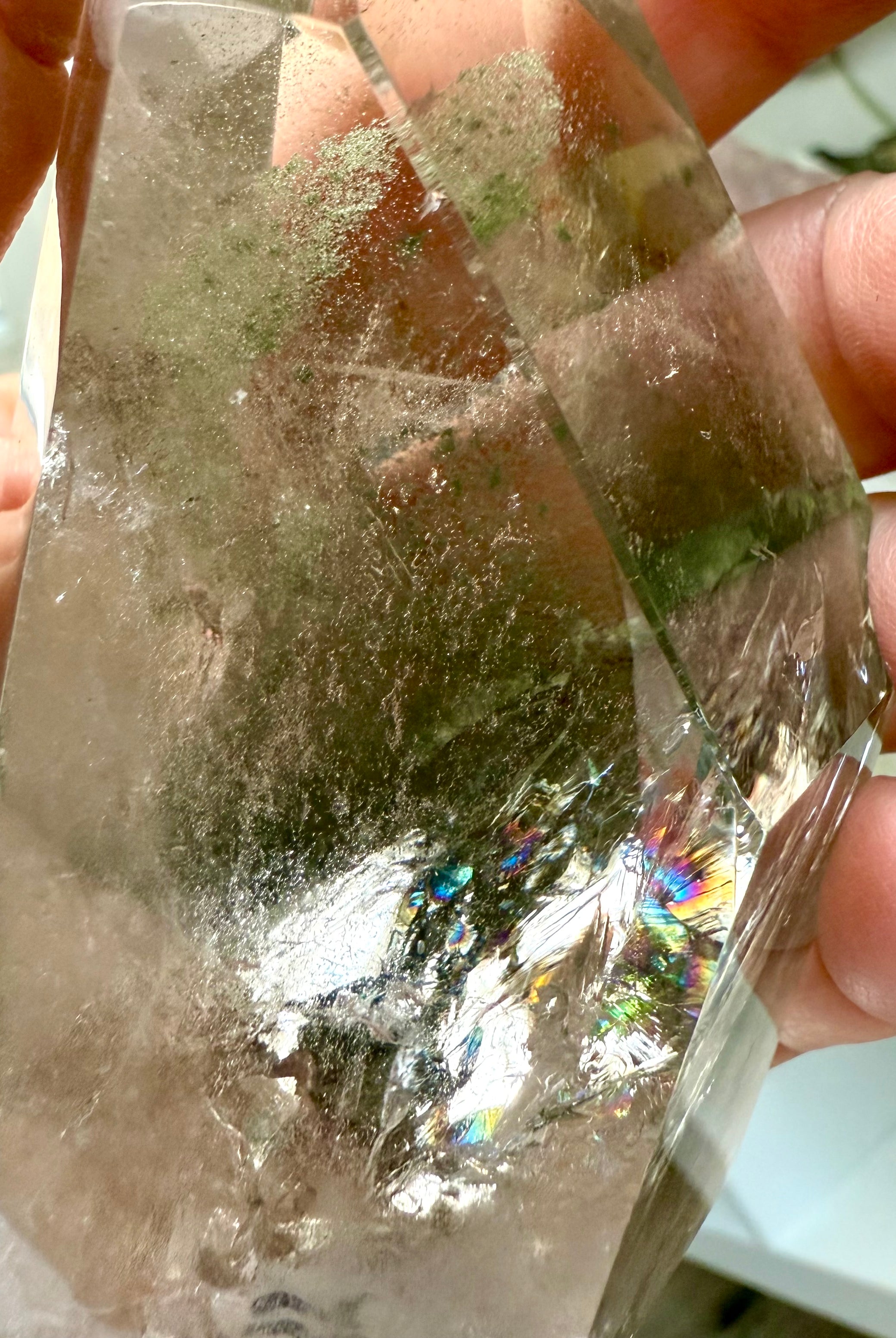 Close up of Garden Quartz tower from Brazil with vivid green chlorite inclusions and rainbow flashes