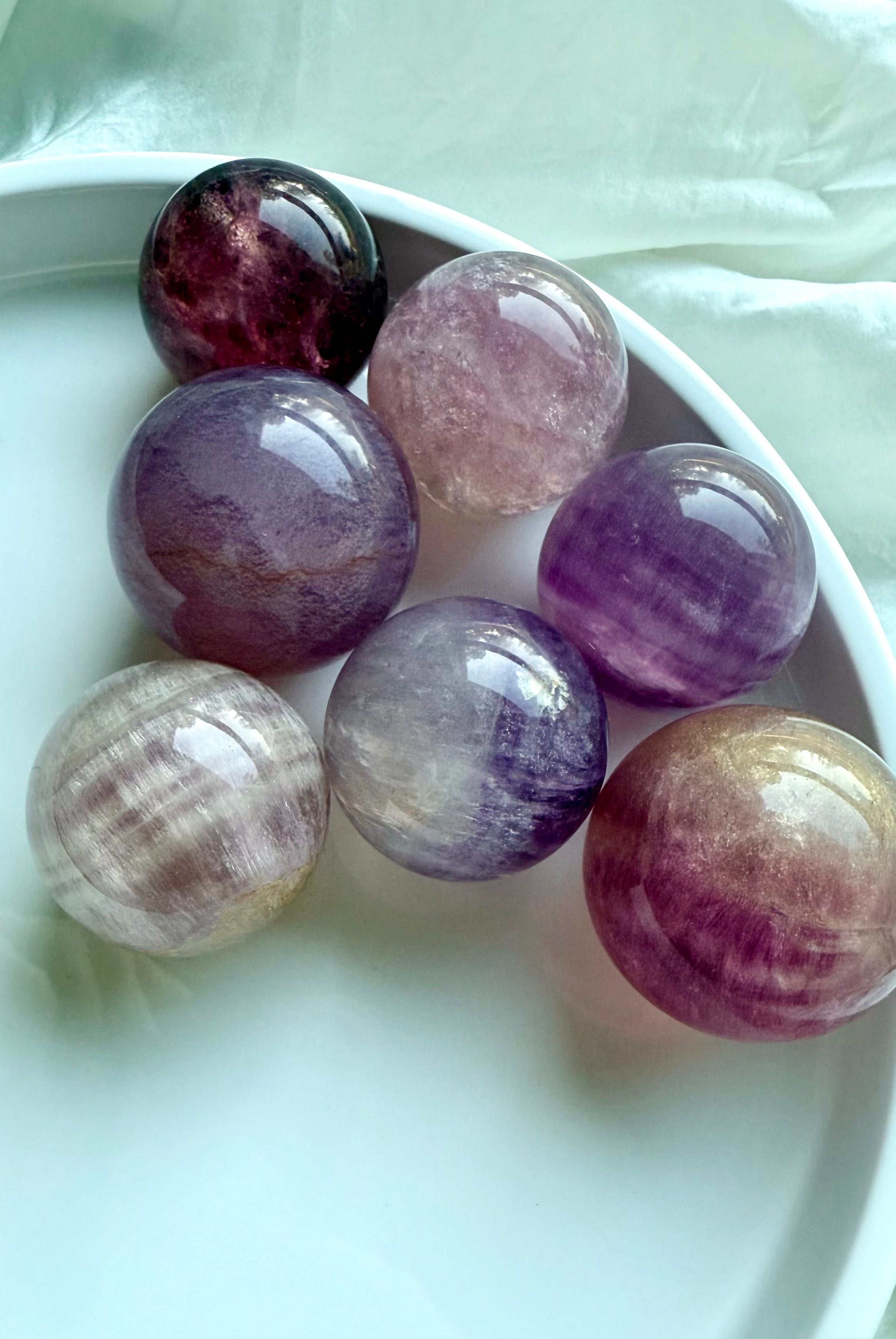 Silky Magenta Fluorite spheres in pastel pink and purple tones with natural banding for intuition and emotional healing