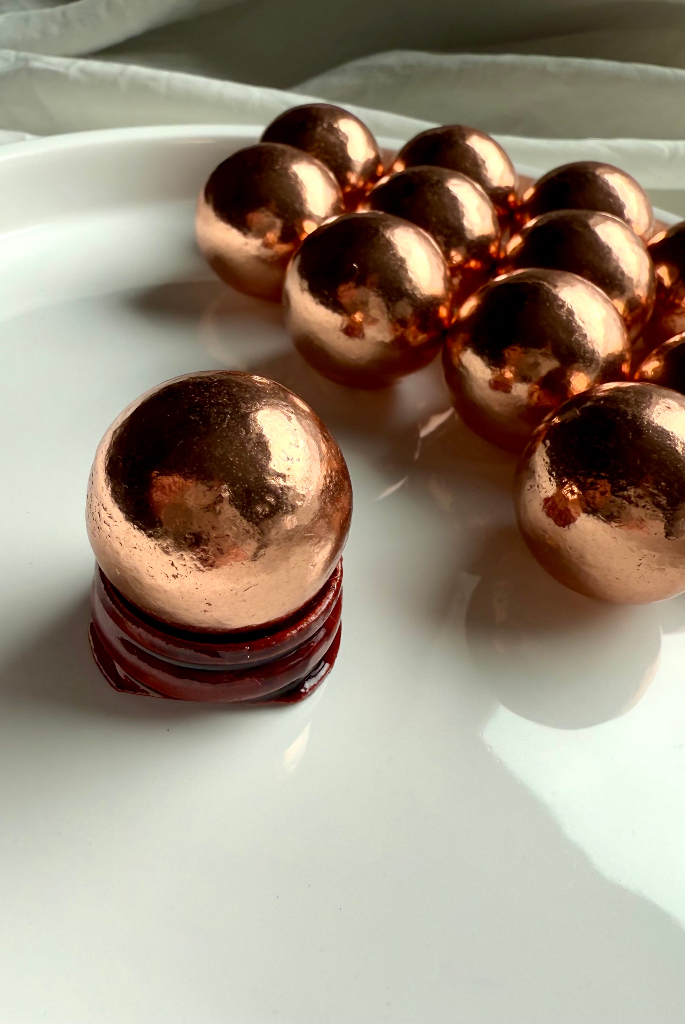 Michigan copper spheres shown in the simple wood stand option available in the dropdown menu