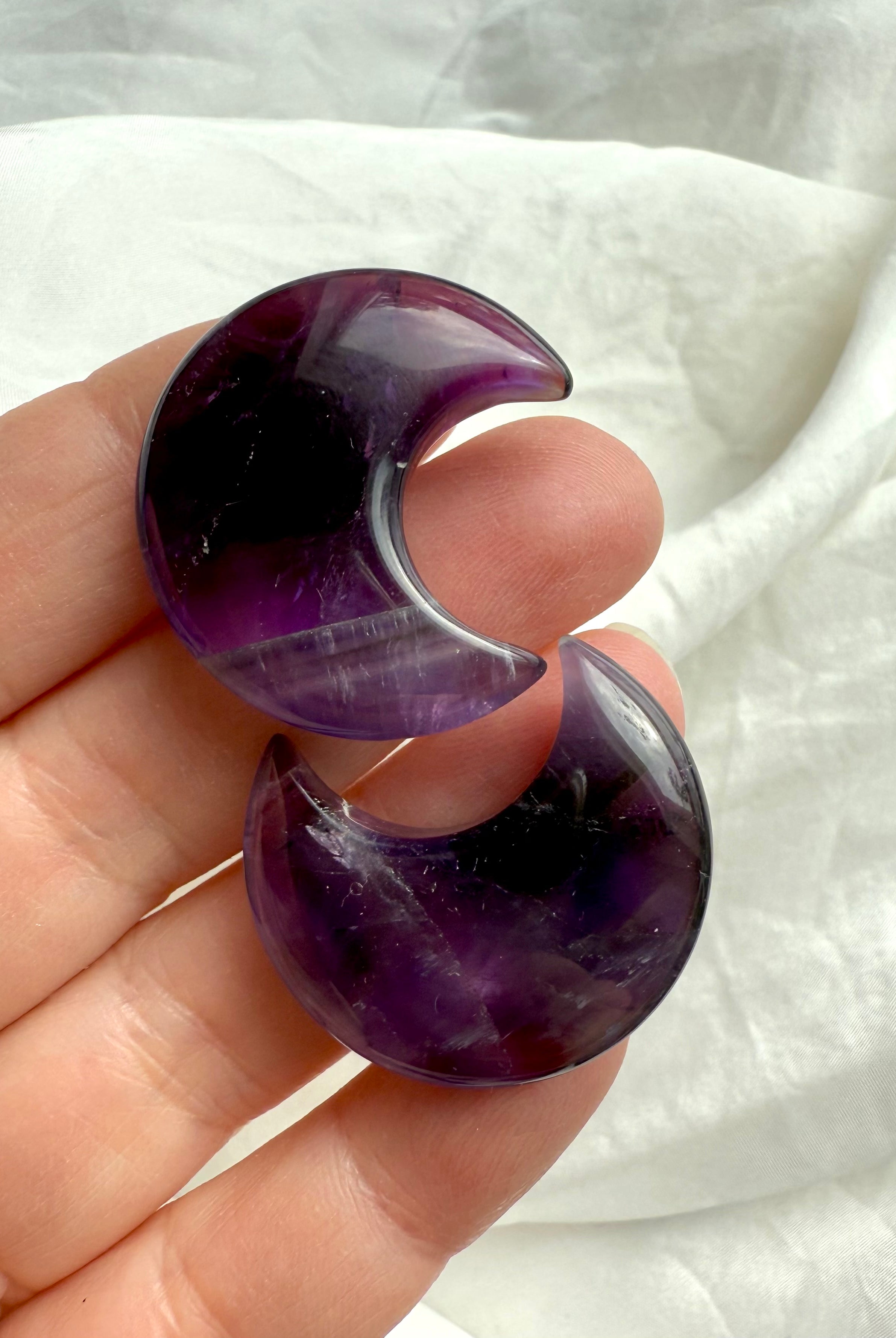 High quality deep purple Dream Amethyst Moons shown on my fingertips for scale