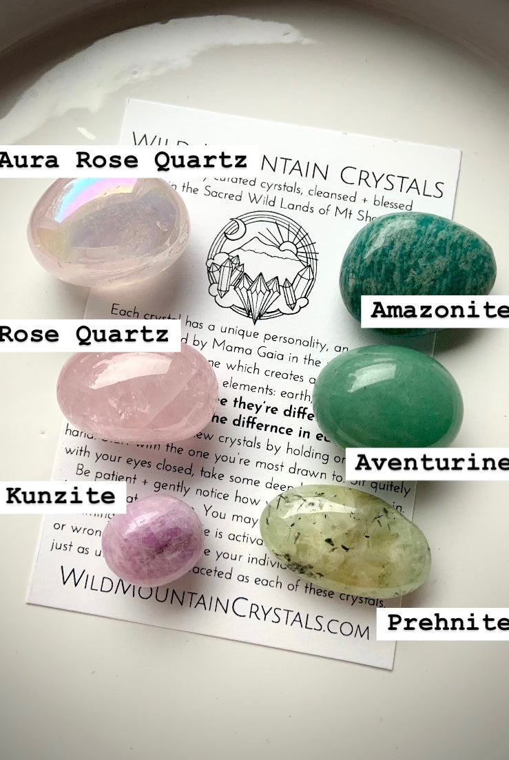 Heart Chakra crystal set labeled with stone names — aura rose quartz, rose quartz, kunzite, amazonite, prehnite, and green aventurine on with info card.