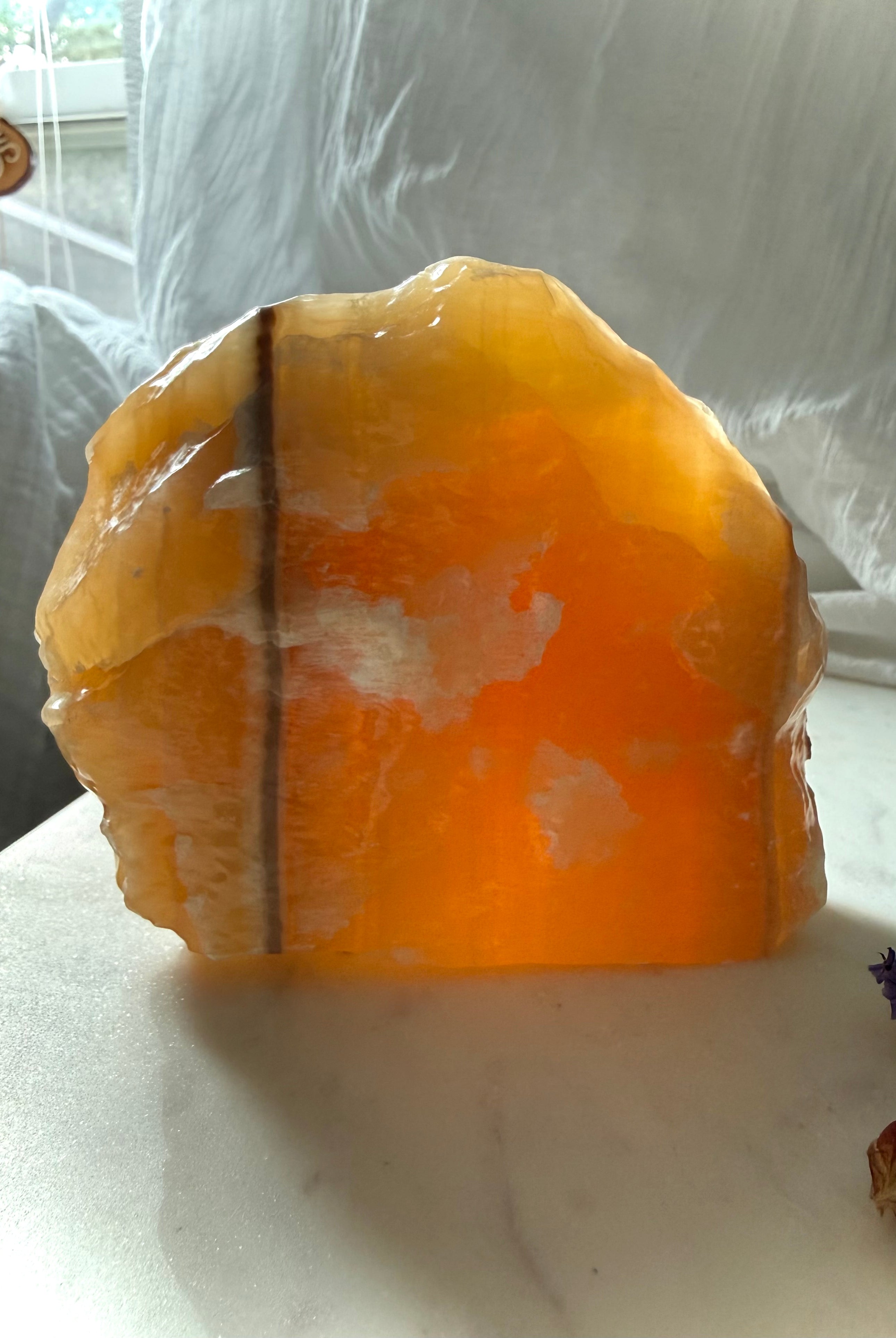 Large translucent Orange Calcite display specimen from Mexico with glowing honey orange color and natural mineral banding