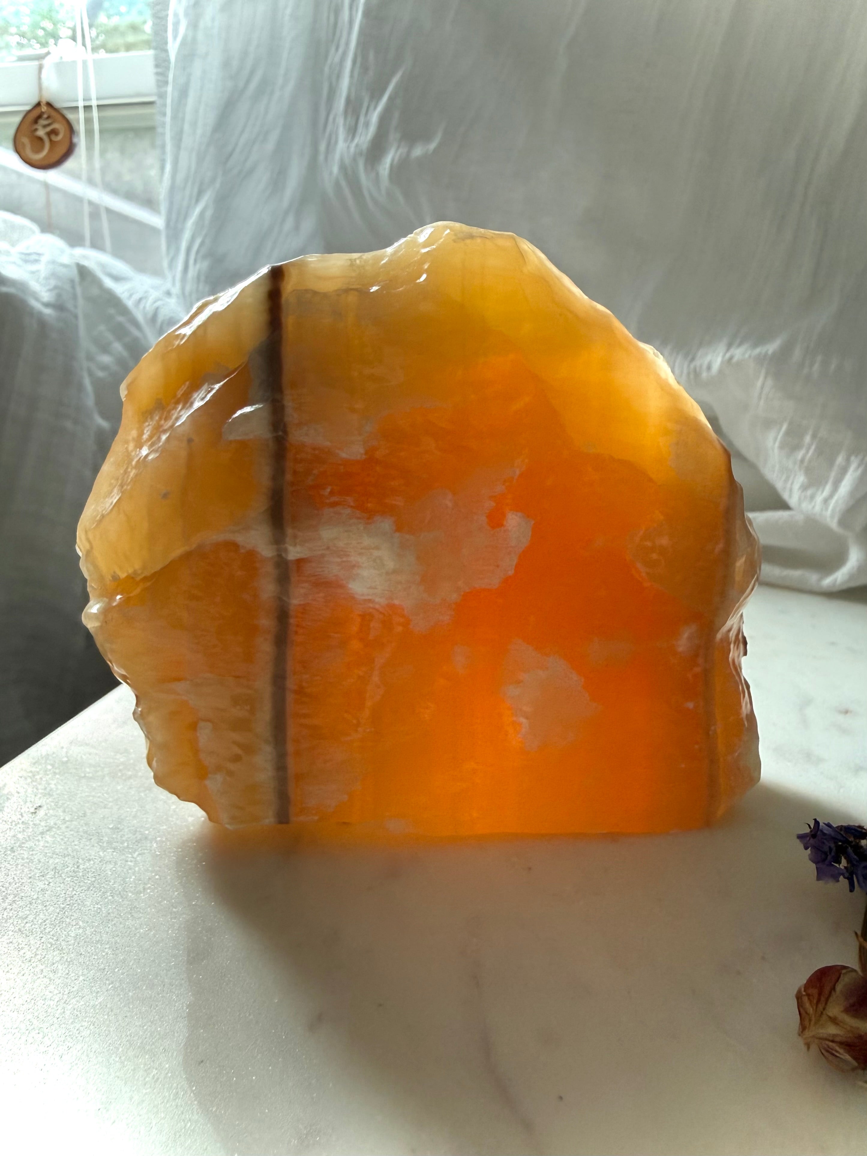 Large translucent Orange Calcite display specimen from Mexico with glowing honey orange color and natural mineral banding