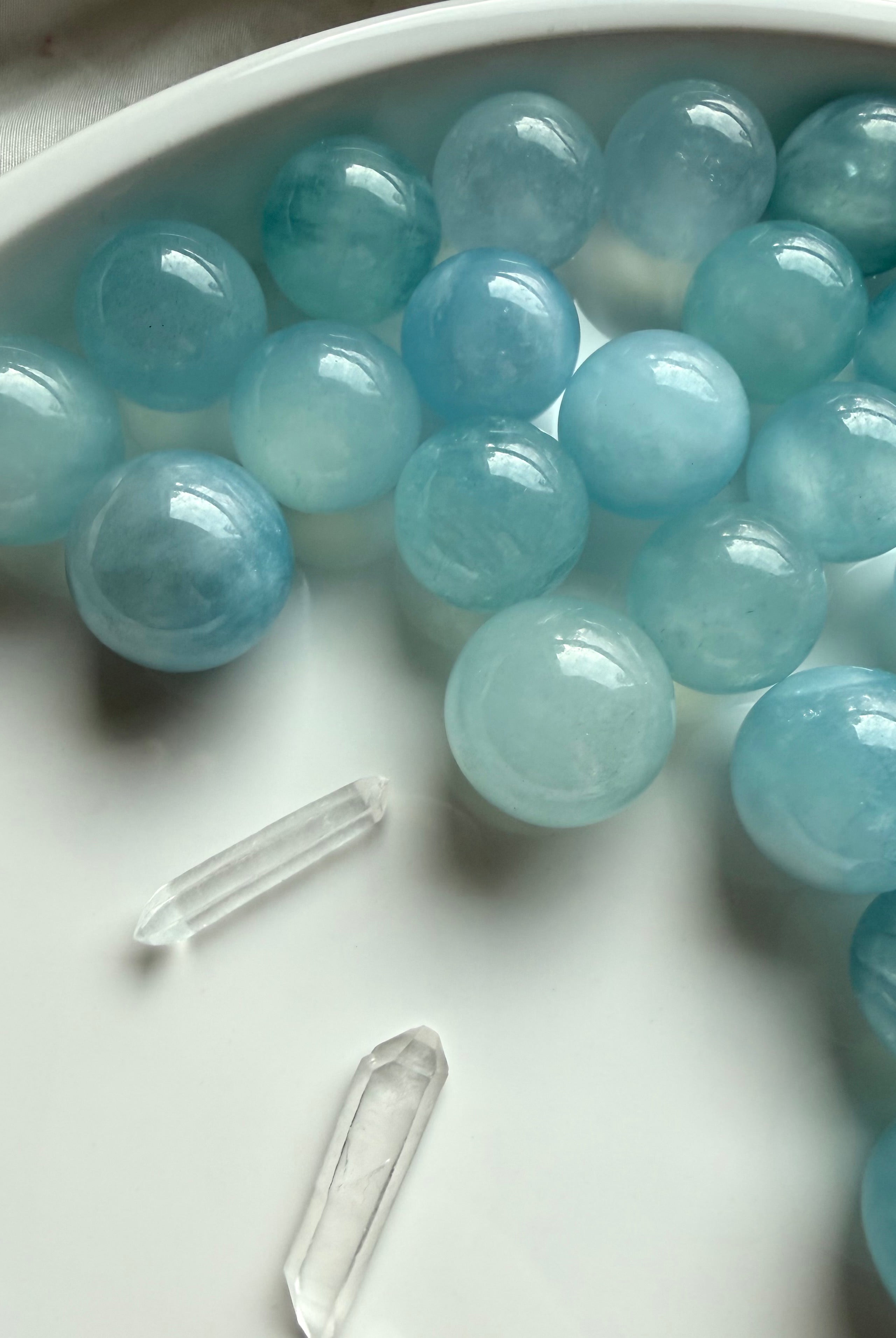 Assorted mini Aquamarine spheres in ocean blue tones – polished March birthstone crystal balls