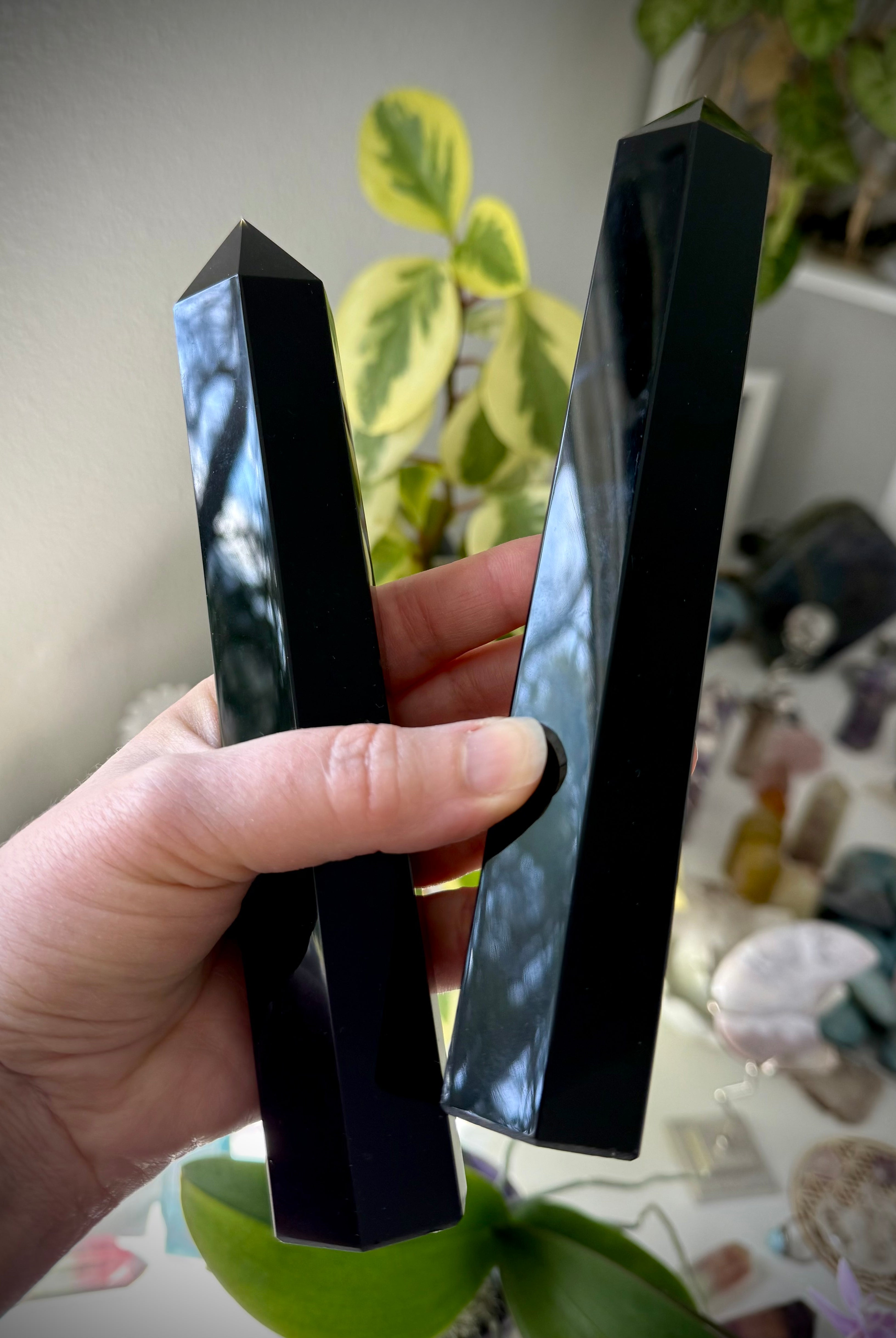 Two large Black Obsidian towers held in hand — reflective crystals for shielding & grounding.