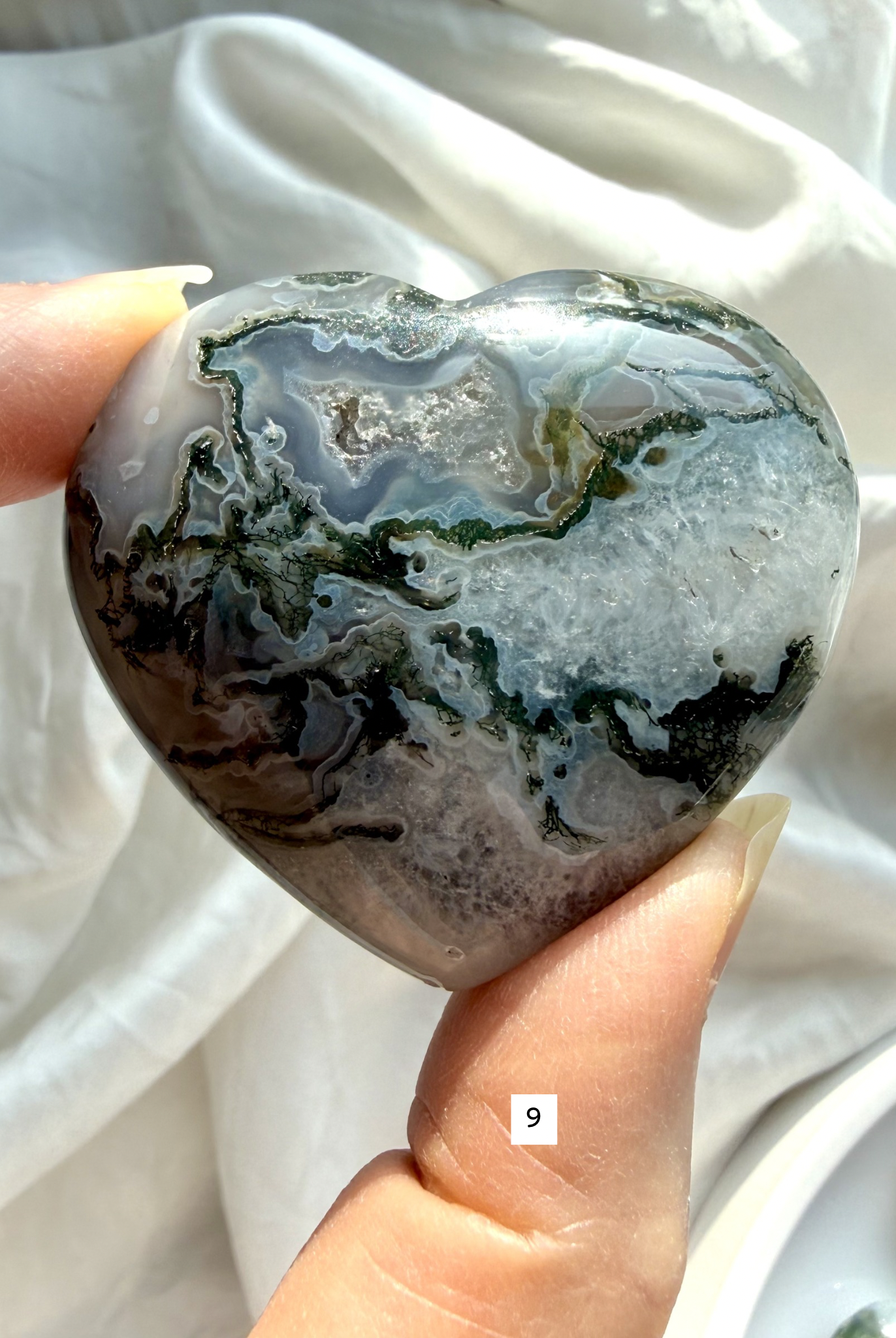 moss agate heart carving option 9 in hand with mossy green formations and soft translucent stone areas