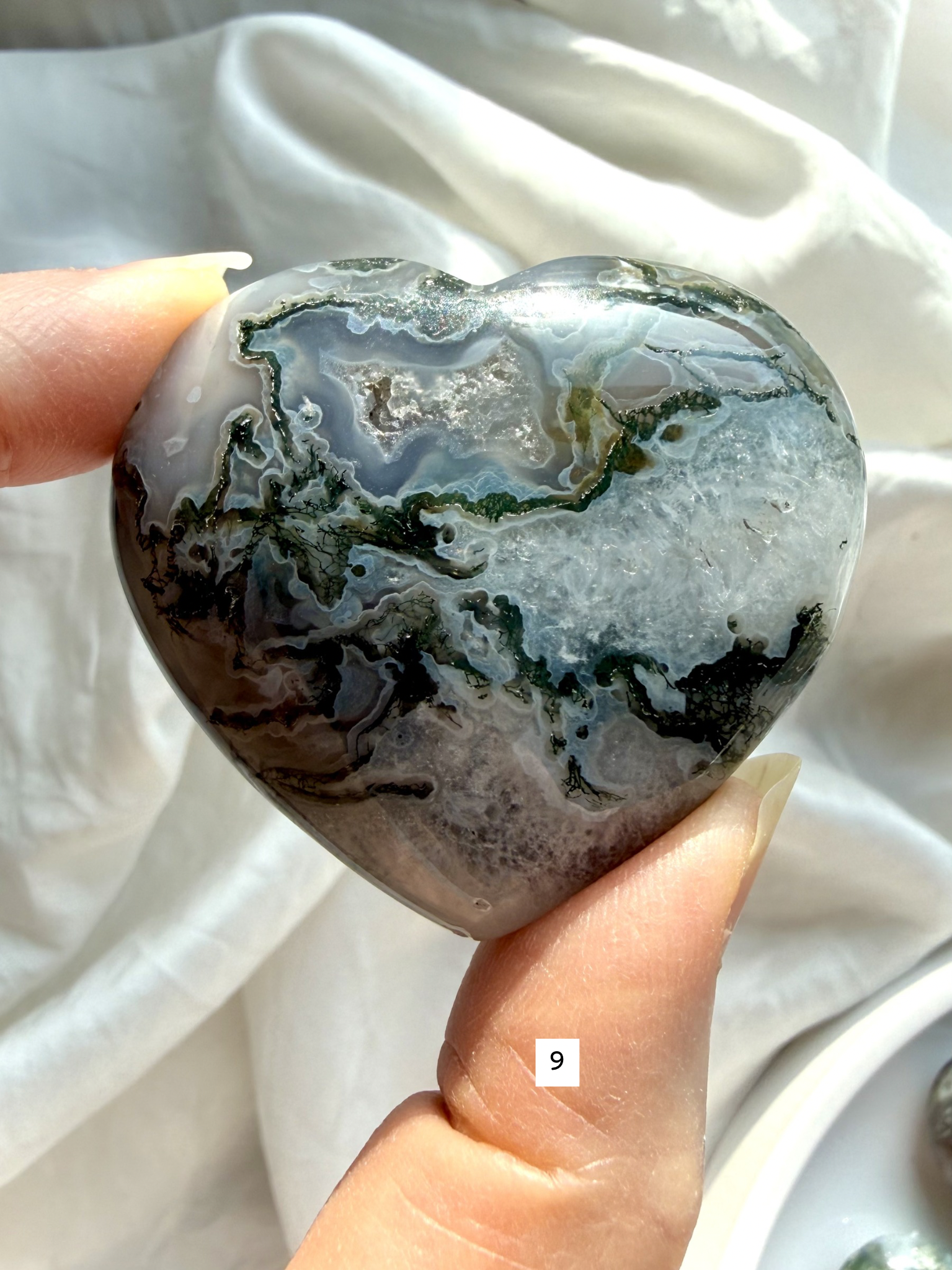 moss agate heart carving option 9 in hand with mossy green formations and soft translucent stone areas