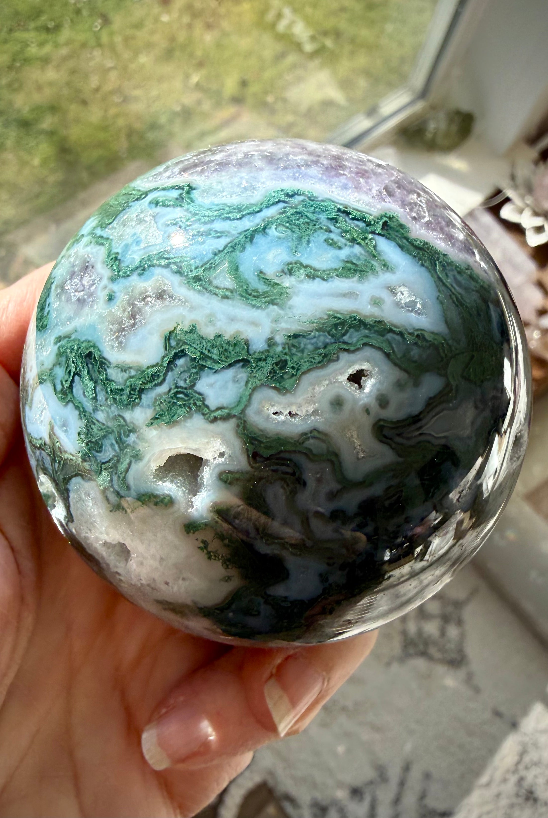 Moss Agate and Amethyst sphere showing polished crystal details with earthy green and purple colors