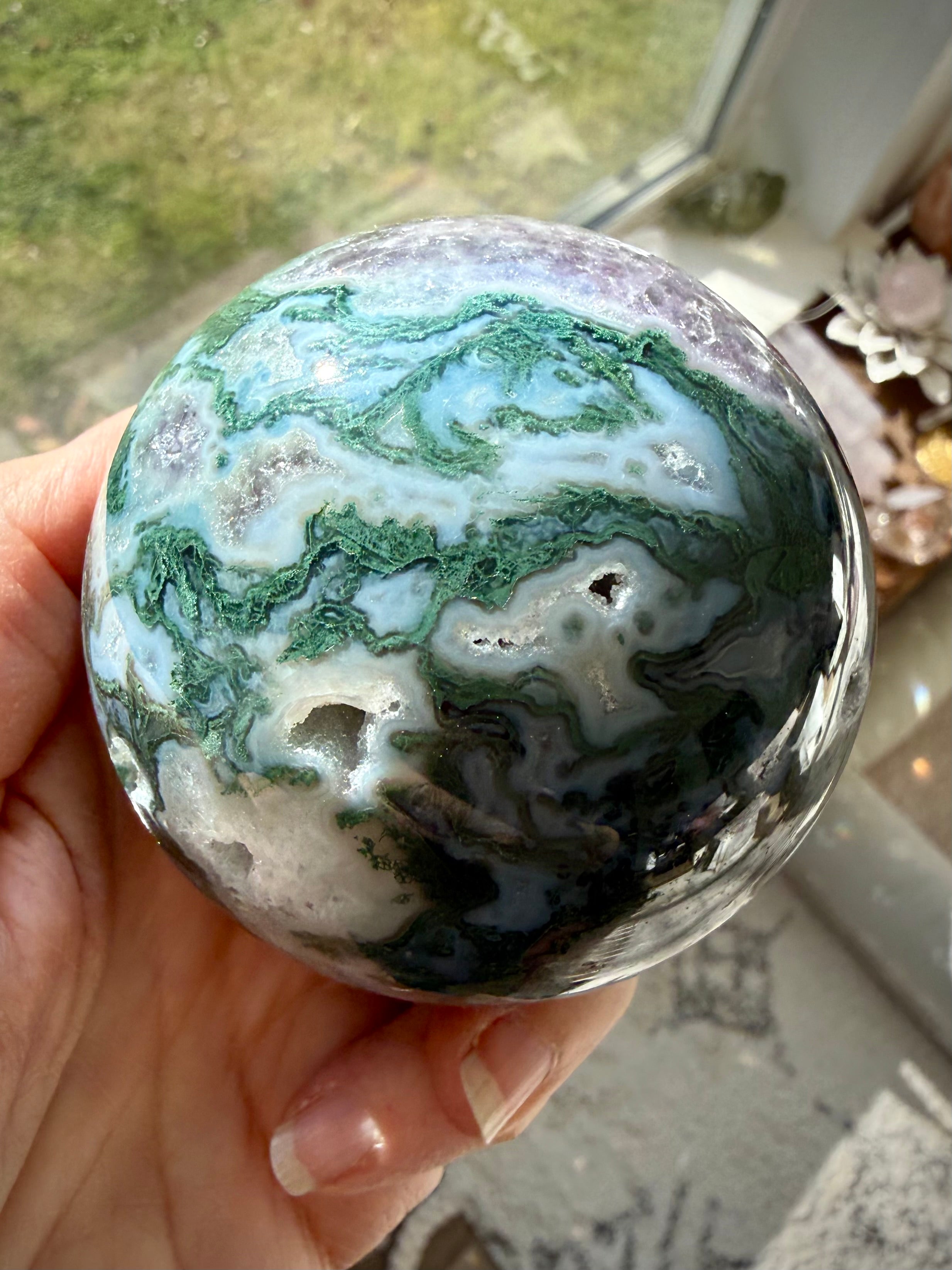 Moss Agate and Amethyst sphere showing polished crystal details with earthy green and purple colors