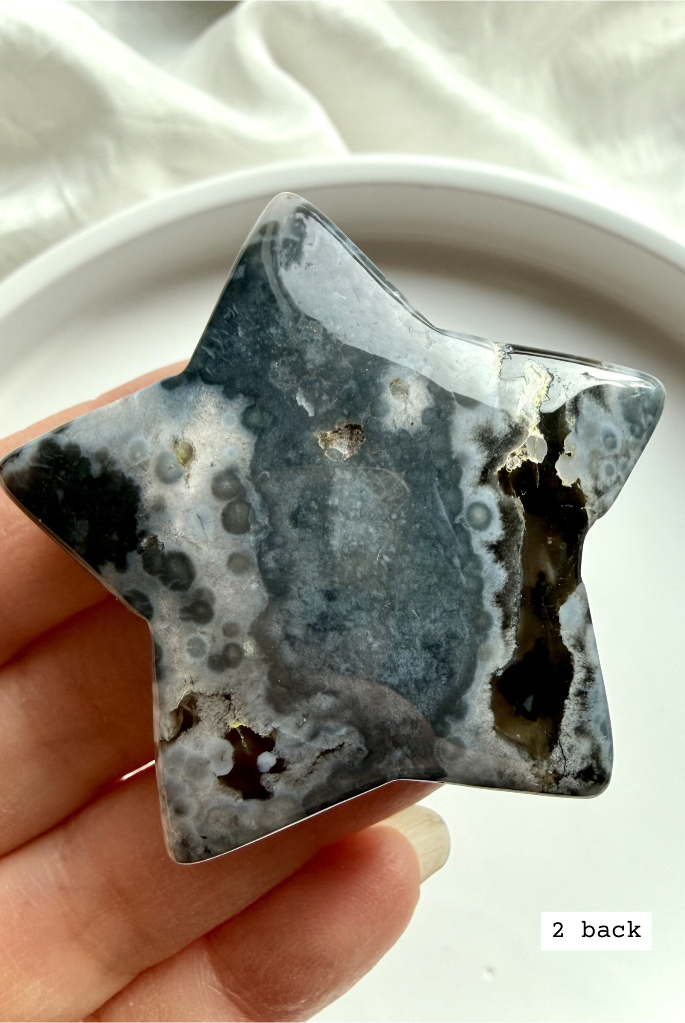 black flower agate star carving #2 back showing natural agate variation and soft bloom inclusions
