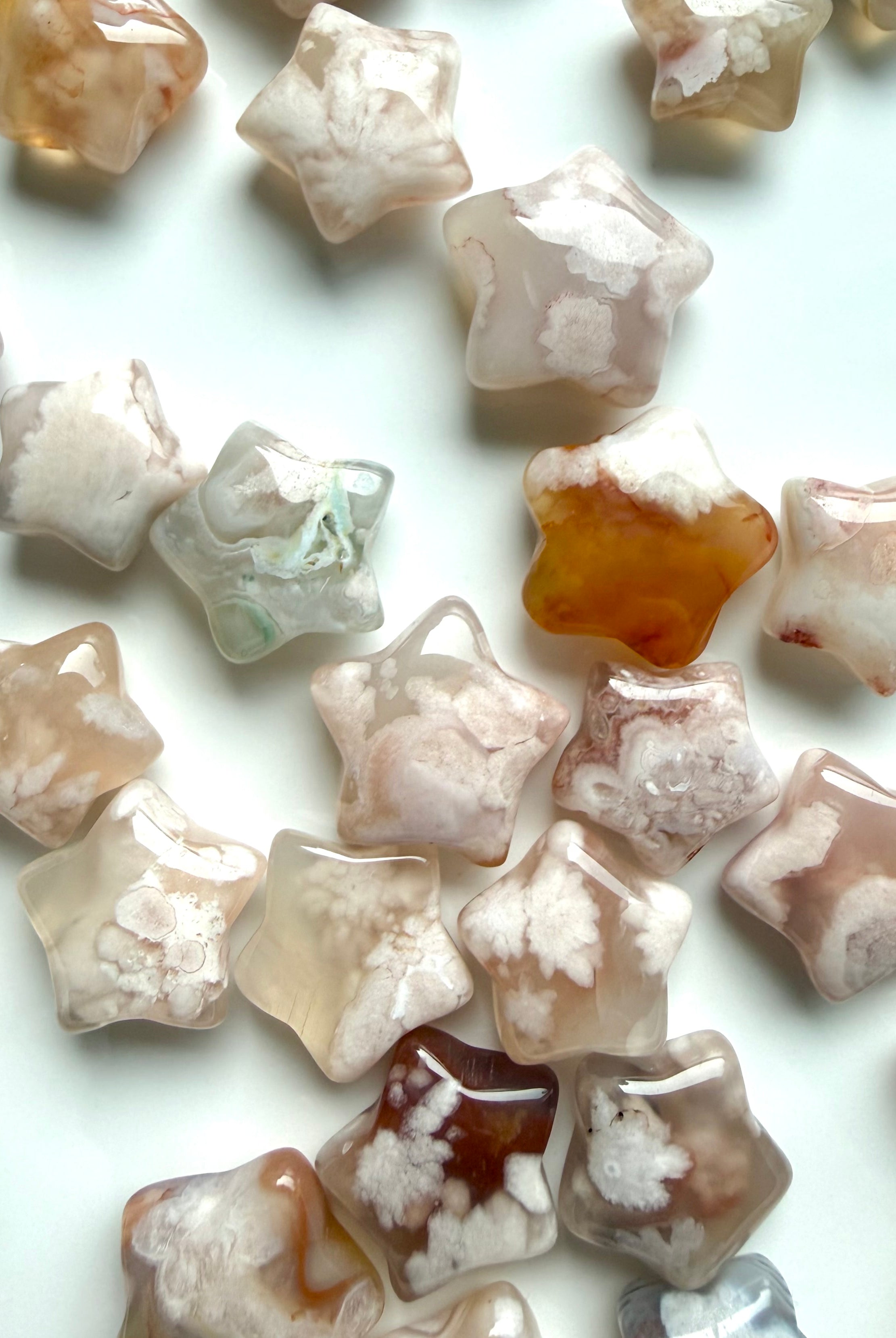 Assorted Flower Agate stars with translucent chalcedony, floral plumes, and natural blush pink variation