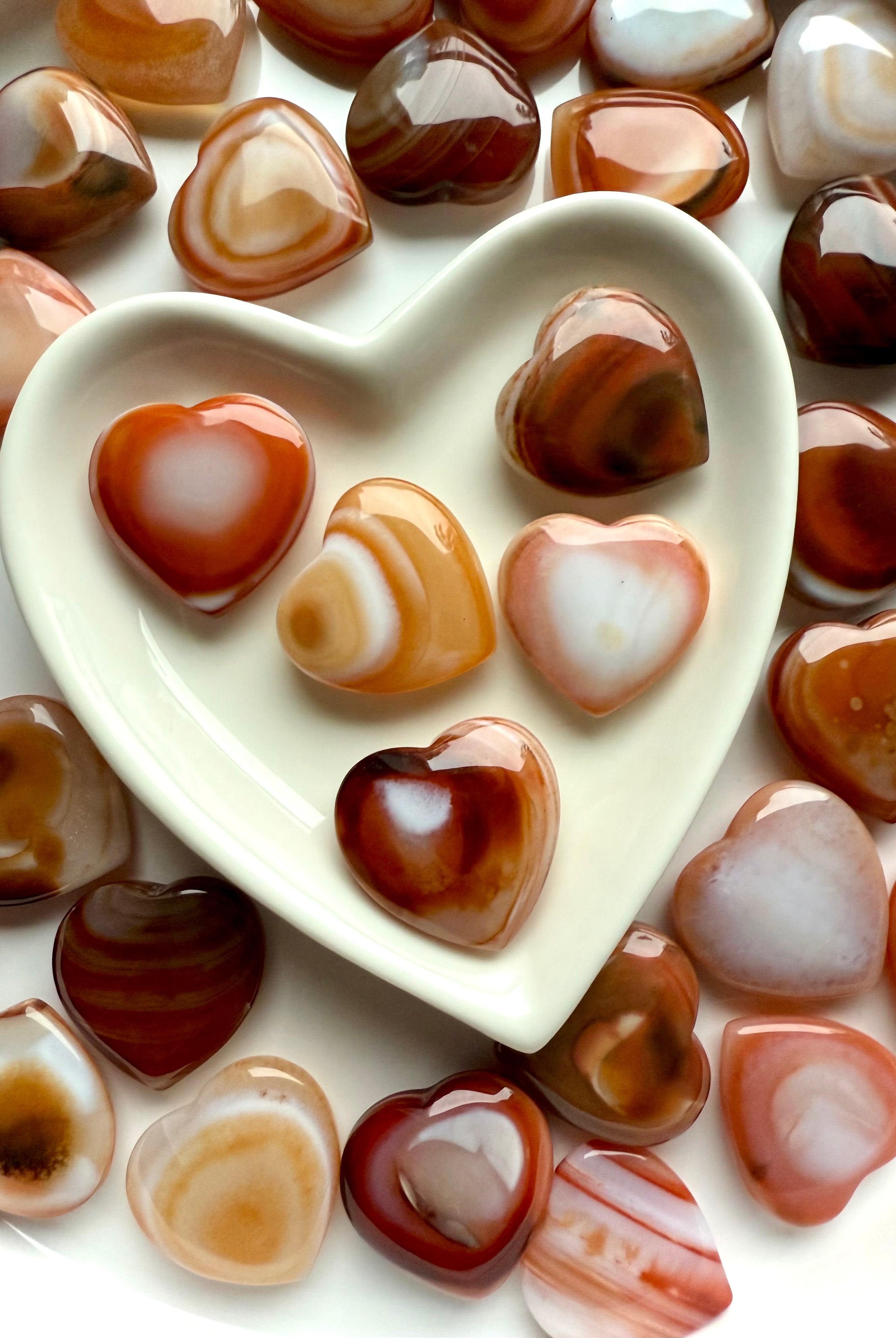 Mini Carnelian Hearts styled in ceramic heart bowl, Sacral Chakra crystals for ritual and meditation