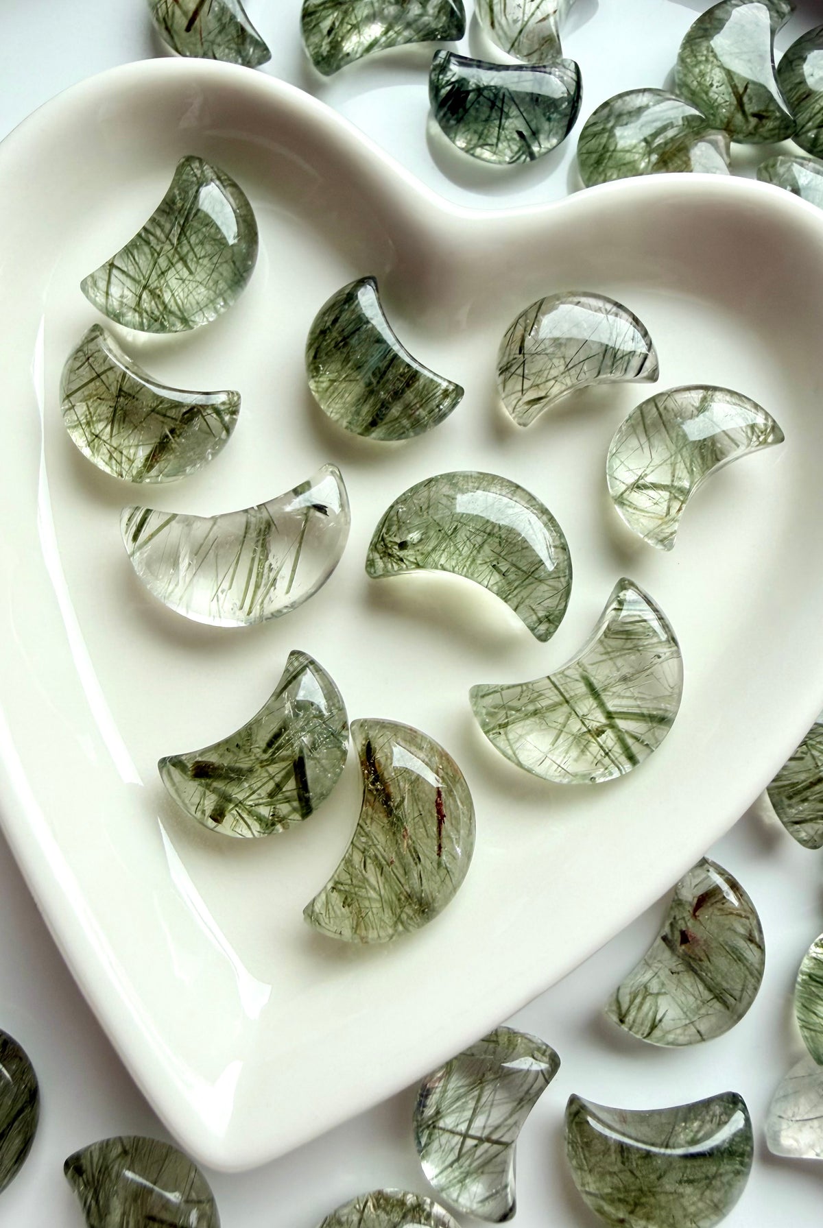 Mini Tourmalinated Quartz moons with green tourmaline needles arranged in a heart-shaped crystal dish