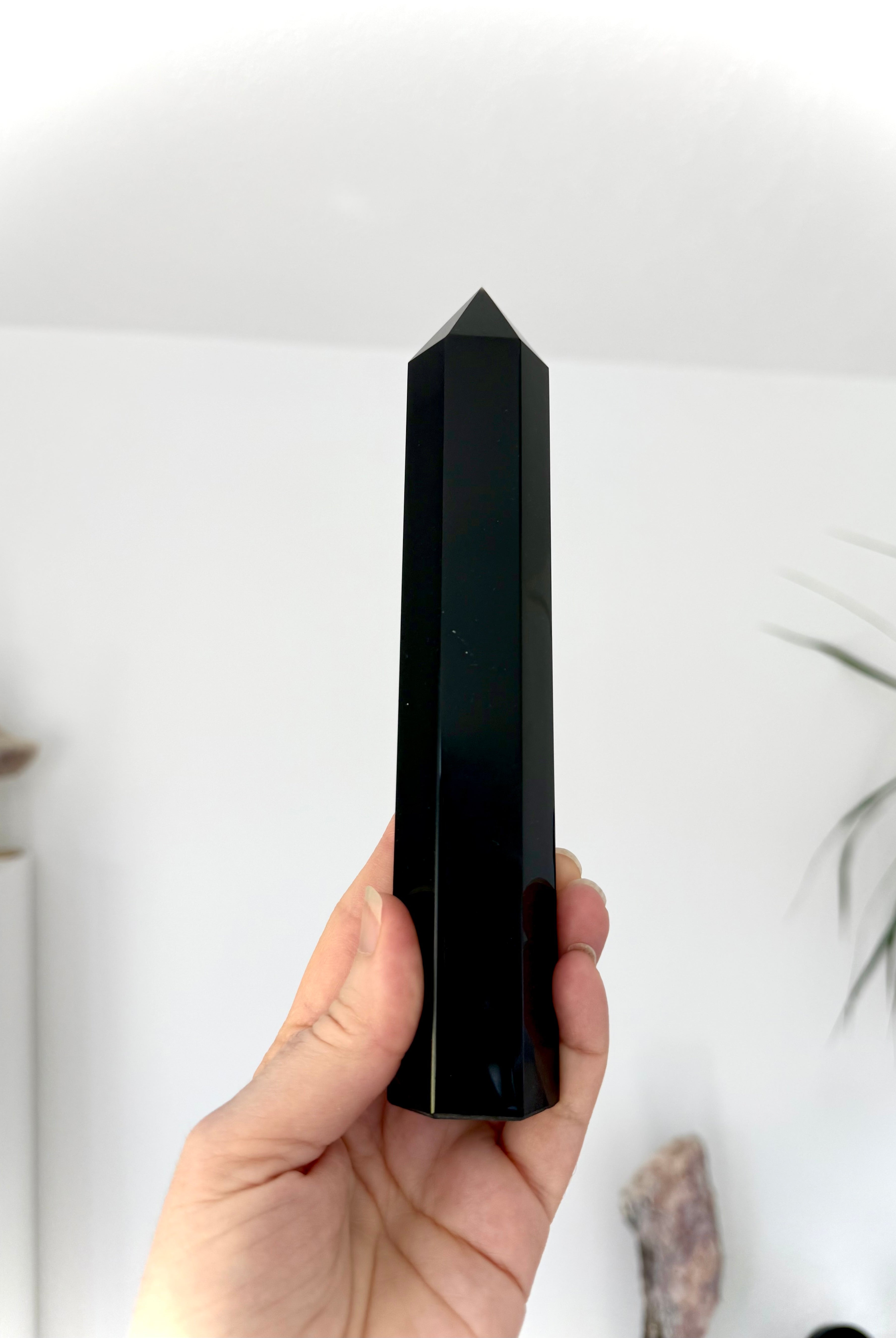 Large Black Obsidian tower held upright — polished Root Chakra crystal for clarity & protection.