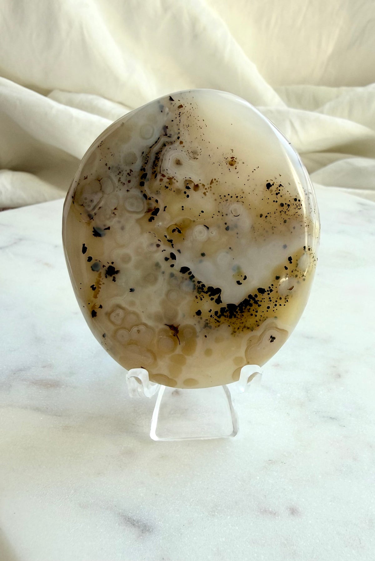 Dendritic Agate crystal on stand, showing cream-colored Agate and intricate natural dendritic patterns, reverse side