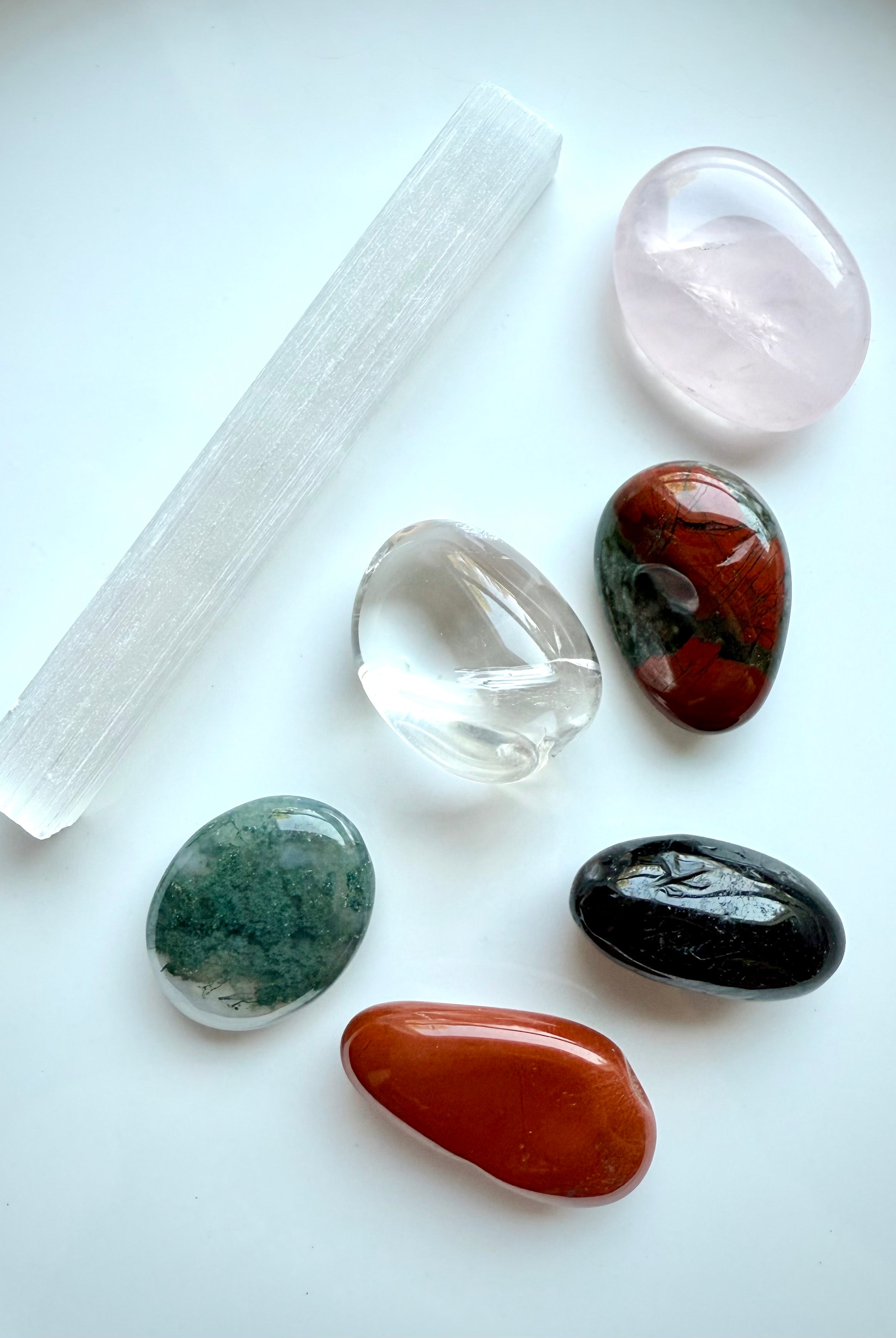 Get Well healing crystals shown on white background, including Selenite and Rose Quartz