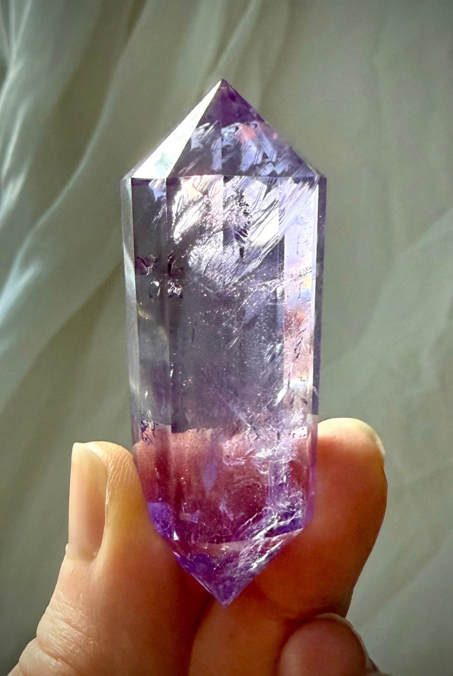 High-clarity Amethyst Vogel cut wand with polished facets and vibrant purple tones