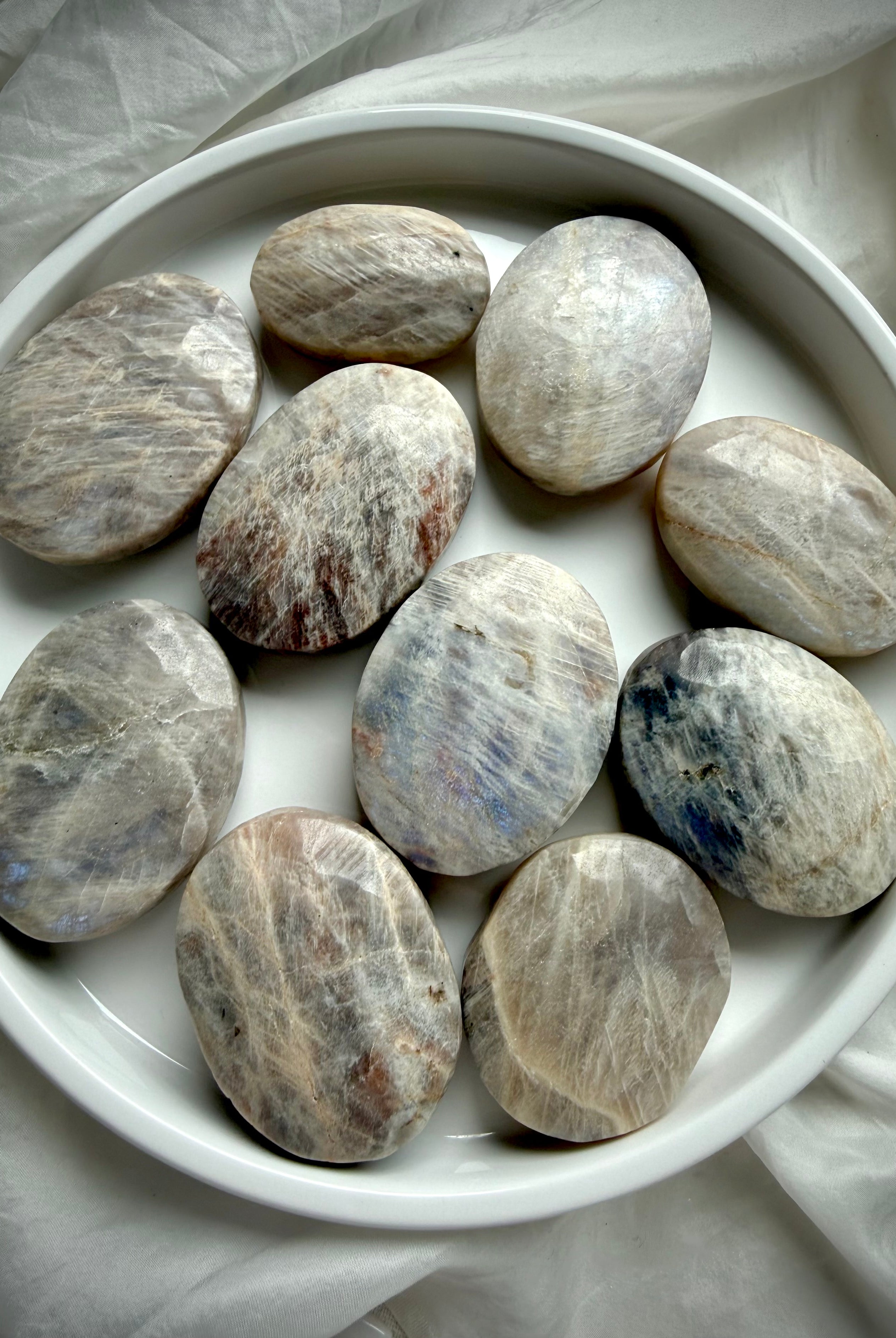 collection of russian moonstone palm stones with natural shimmer and intuitive lunar energy