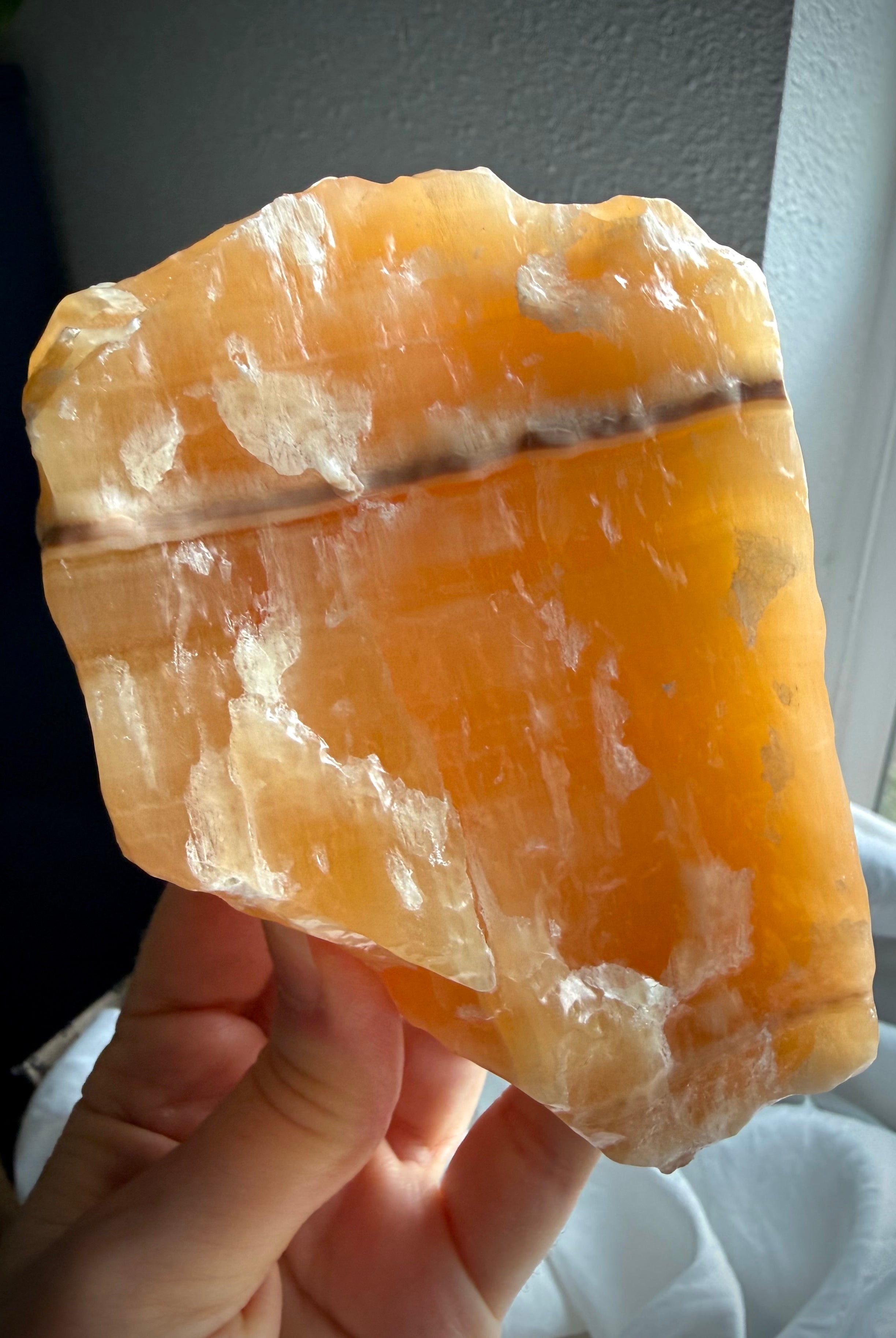 Self-standing Orange Calcite display piece from Mexico with translucent orange coloration and natural mineral layers