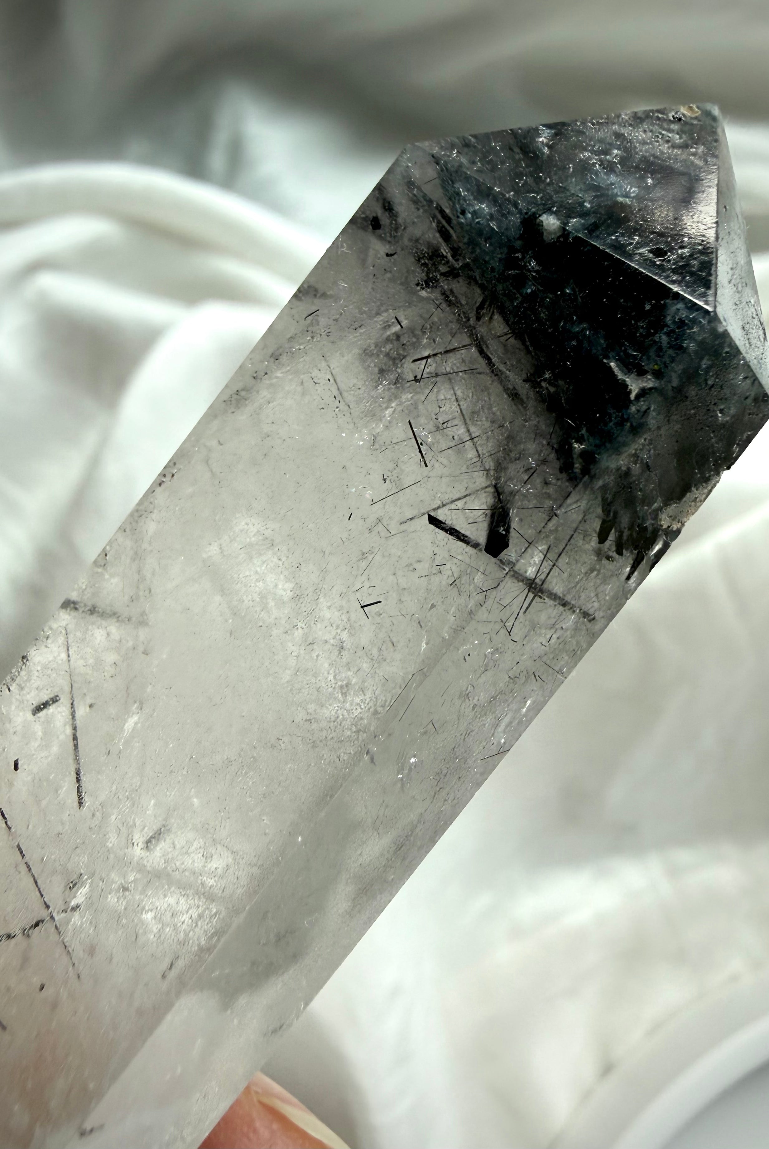 black tourmaline quartz crystal point close up showing black rutile inclusions and clarity