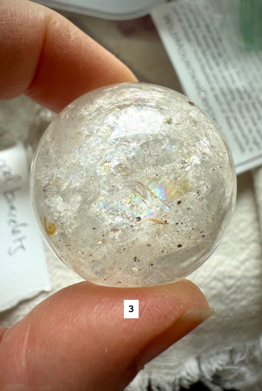 close-up of garden quartz sphere – clear crystal with moss-like inclusions for spiritual growth