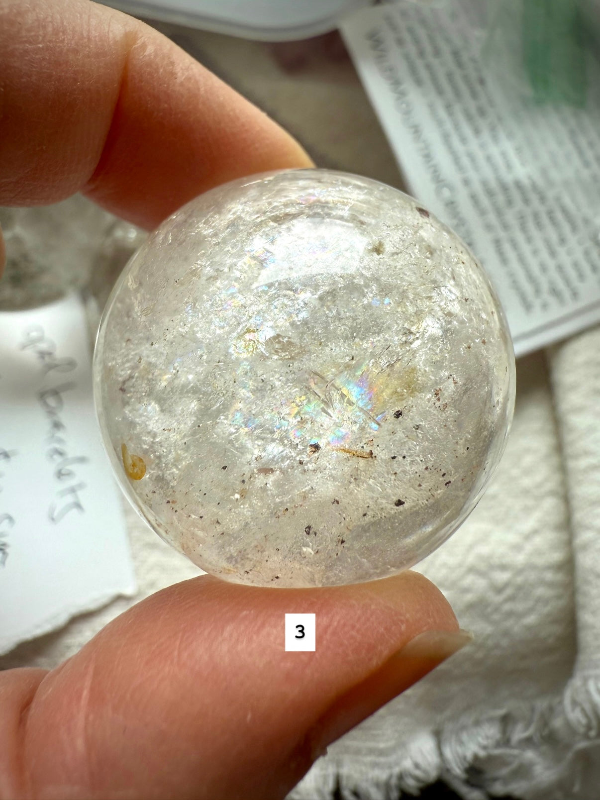 close-up of garden quartz sphere – clear crystal with moss-like inclusions for spiritual growth