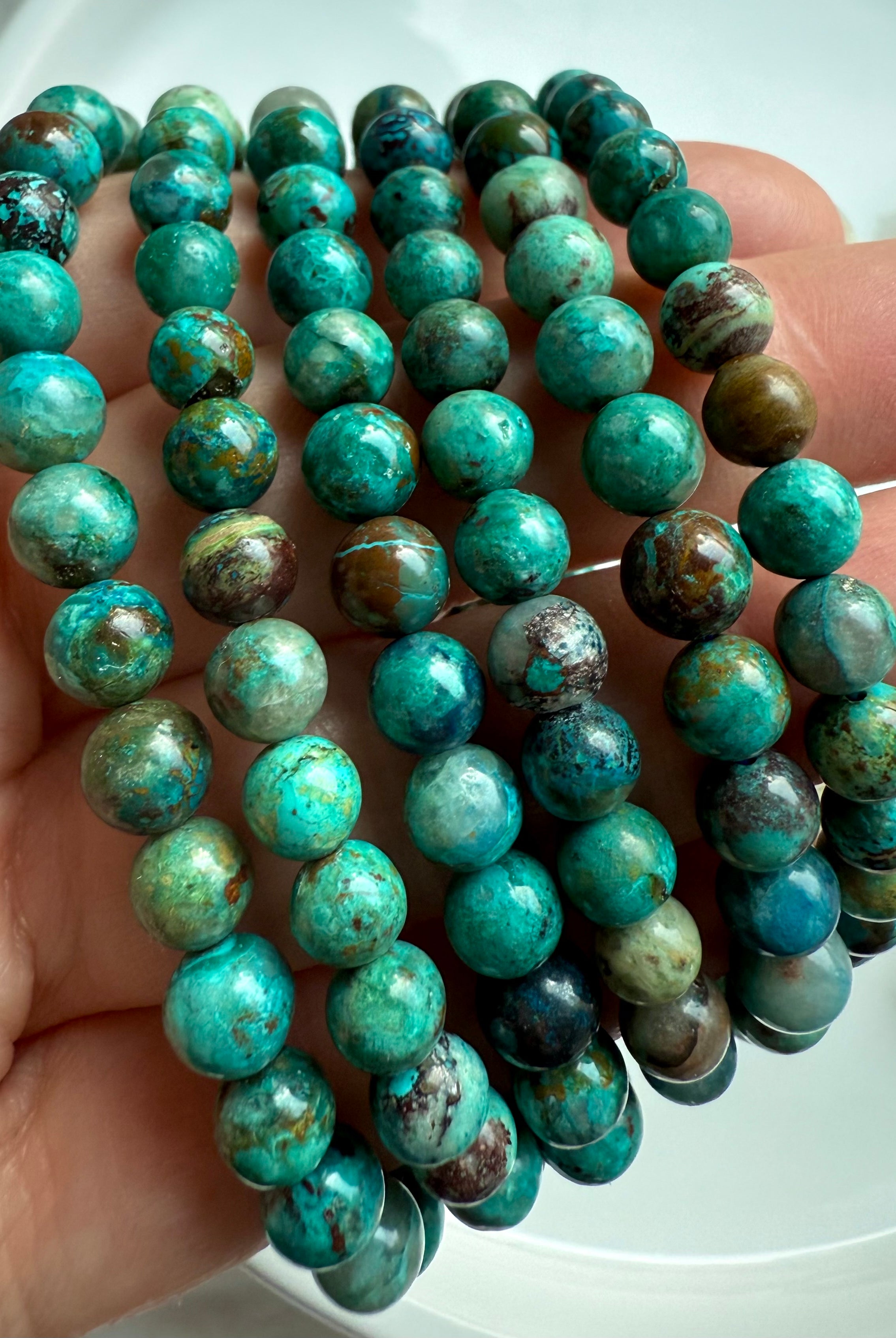 Chrysocolla Shattuckite beaded bracelets wrapped around wrist, turquoise-toned crystal jewelry for throat chakra healing