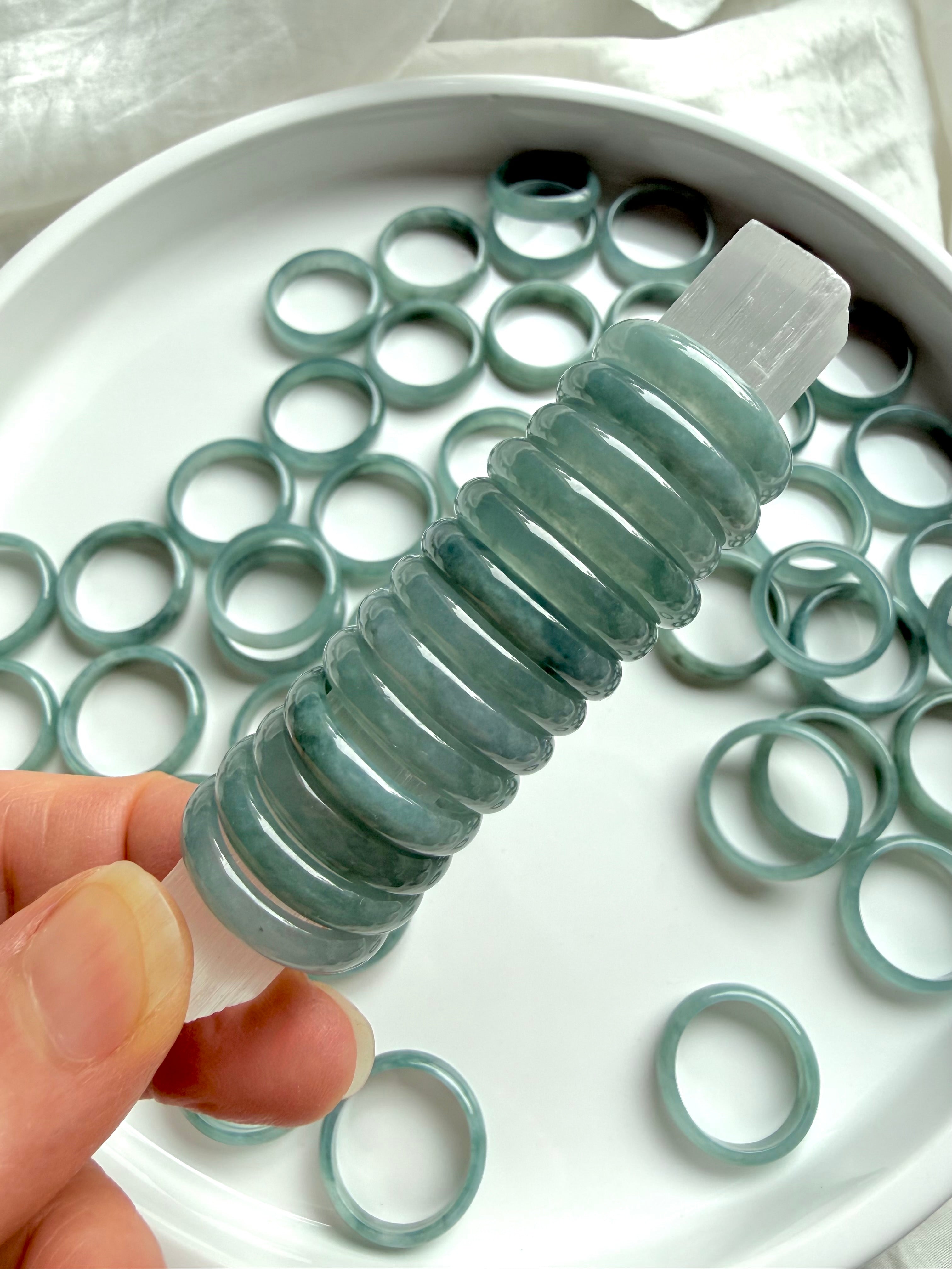 Stack of rounded Blue Water jade rings showing smooth polished jadeite bands