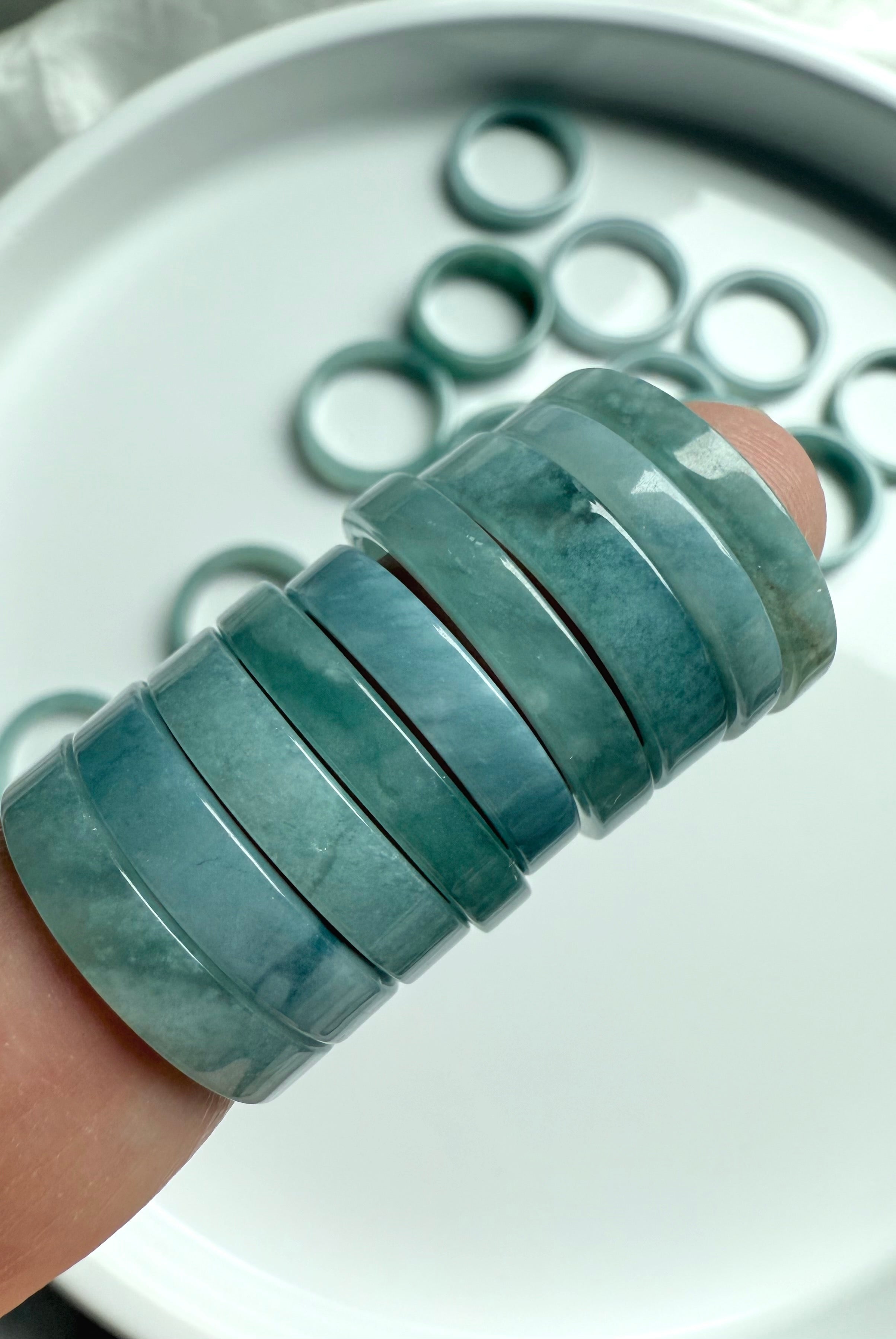 Close-up of smooth Blue Water Jade rings showcasing natural variations in translucent green
