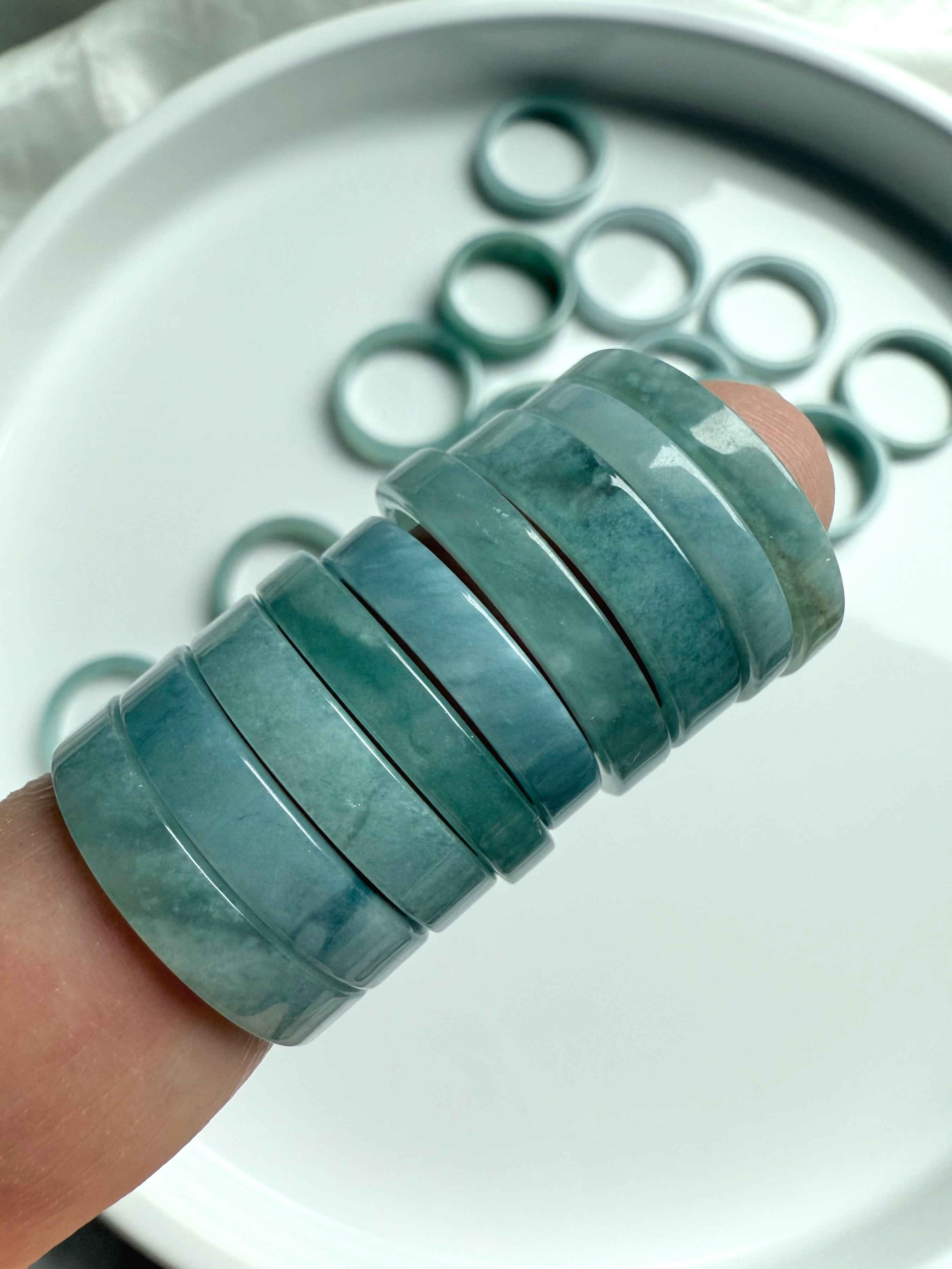Close-up of smooth Blue Water Jade rings showcasing natural variations in translucent green